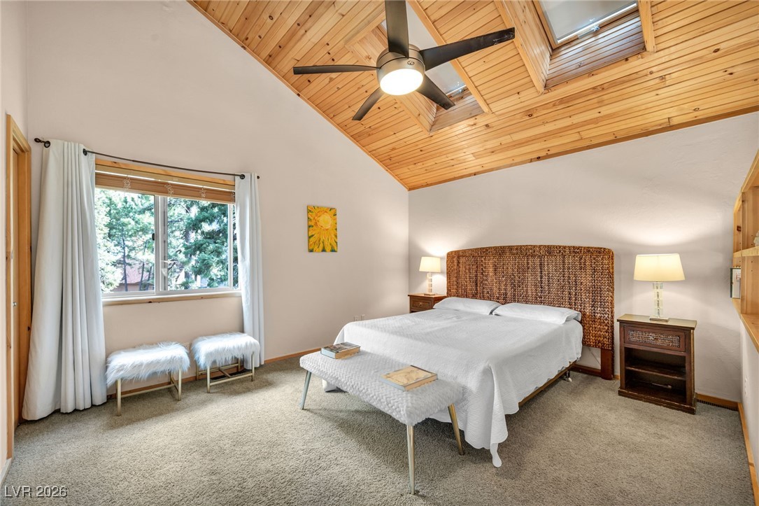 4137 Matterhorn Way Las Vegas, NV 89124 - Photo 48 of 75 Bedroom featuring a skylight, light colored carpet, wood ceiling, high vaulted ceiling, and ceiling fan