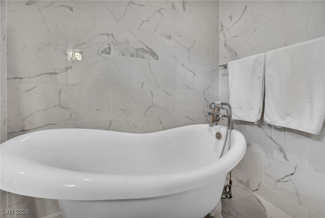 4137 Matterhorn Way Las Vegas, NV 89124 - Photo 56 of 75 Full bathroom with tile walls and a freestanding bath