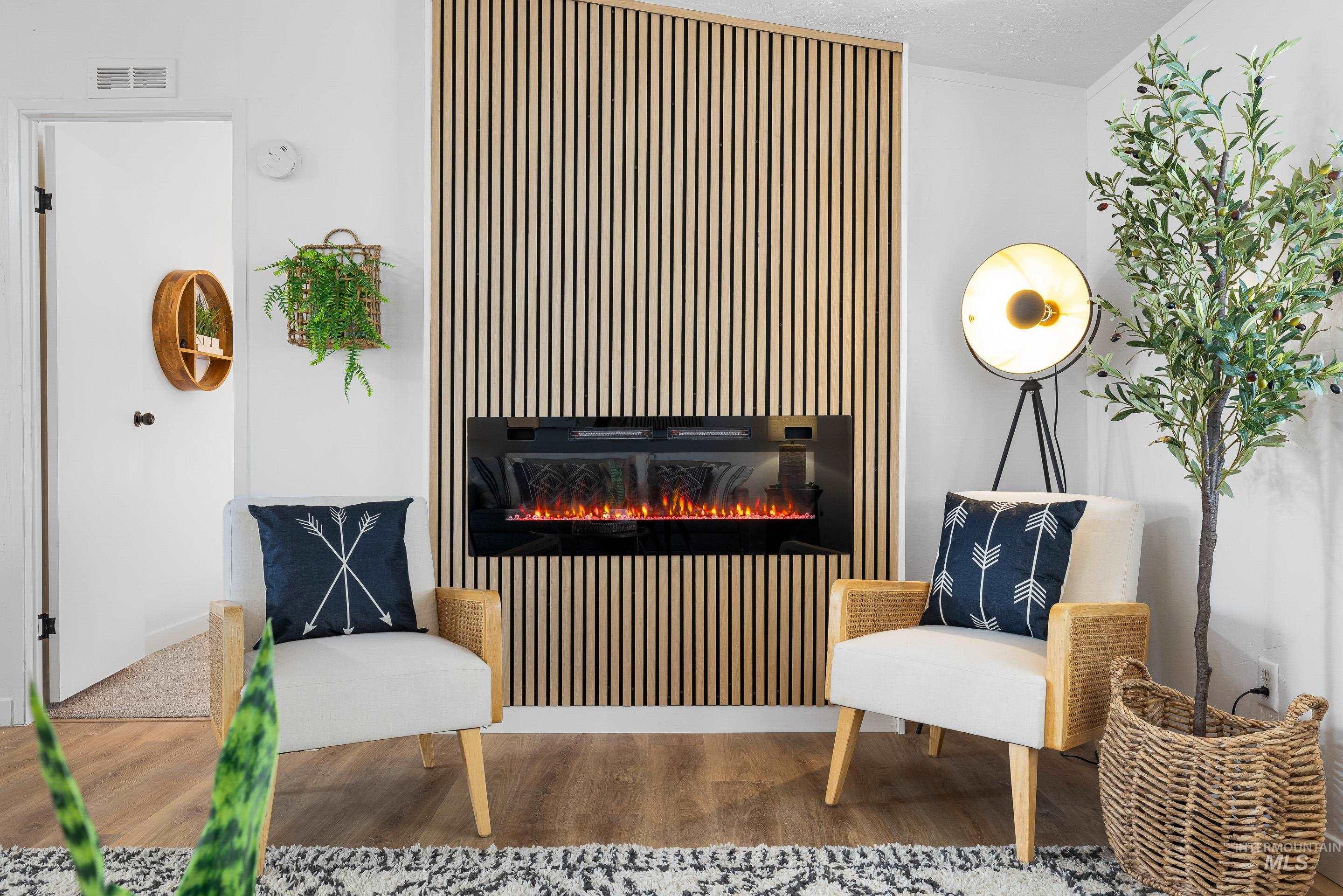 10014 Dewitt Lane Boise, ID 83704 - Photo 12 of 50 Living area featuring wood finished floors and a lit fireplace