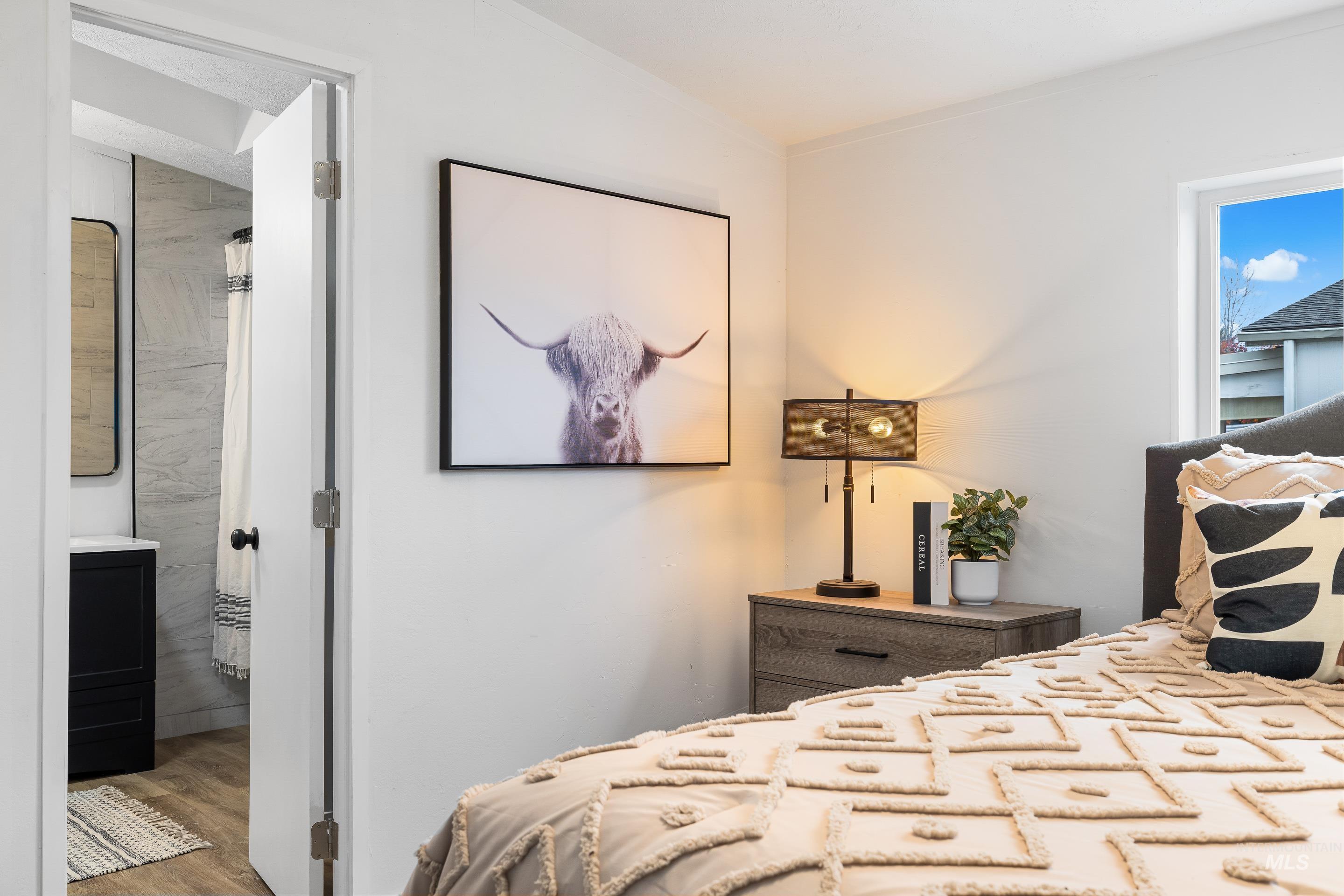 10014 Dewitt Lane Boise, ID 83704 - Photo 32 of 50 Bedroom featuring wood finished floors and ensuite bath