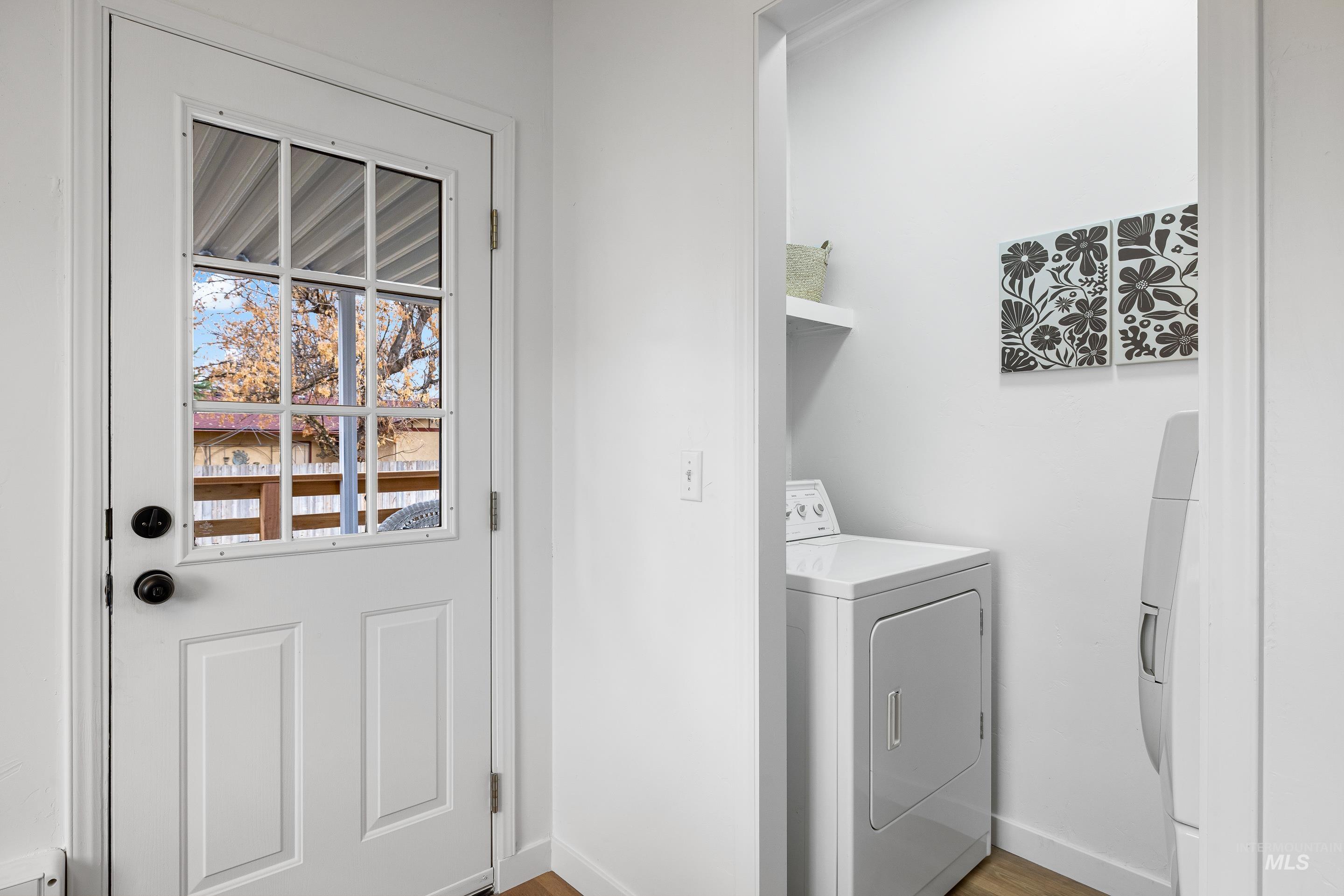 10014 Dewitt Lane Boise, ID 83704 - Photo 43 of 50 Laundry area with light wood finished floors and washing machine and dryer