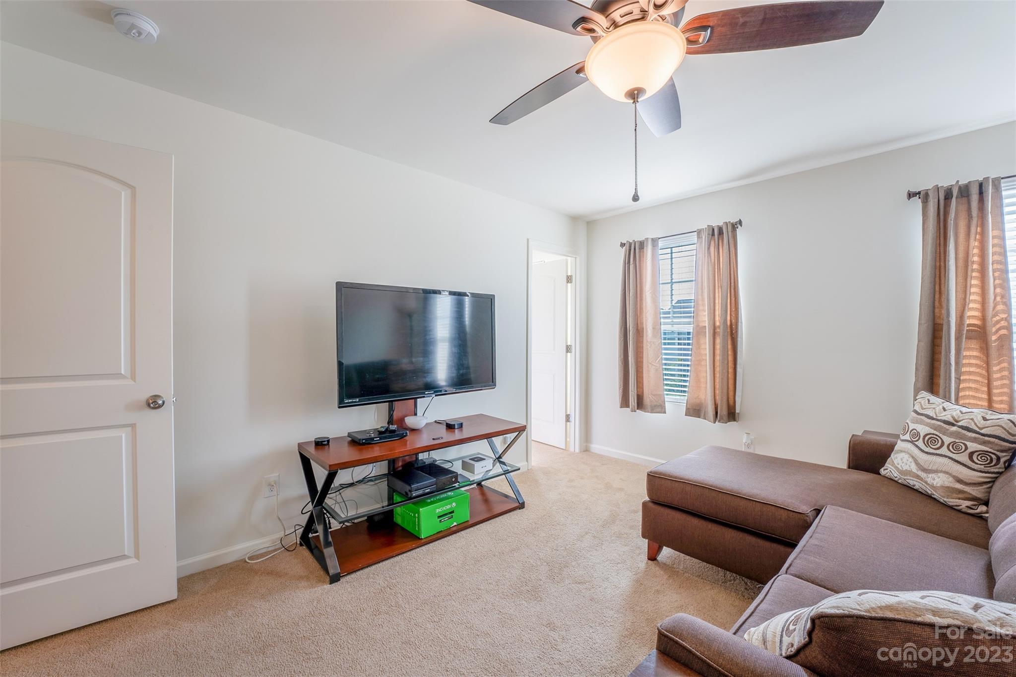 12538 Garron Road Midland, NC 28107 - Photo 24 of 29 a living room with furniture and a flat screen tv