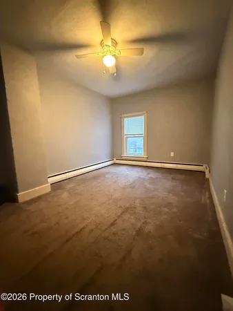 an empty room with a empty space and a ceiling fan