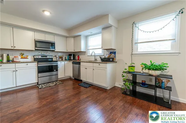 a kitchen with a stove a sink and a refrigerator