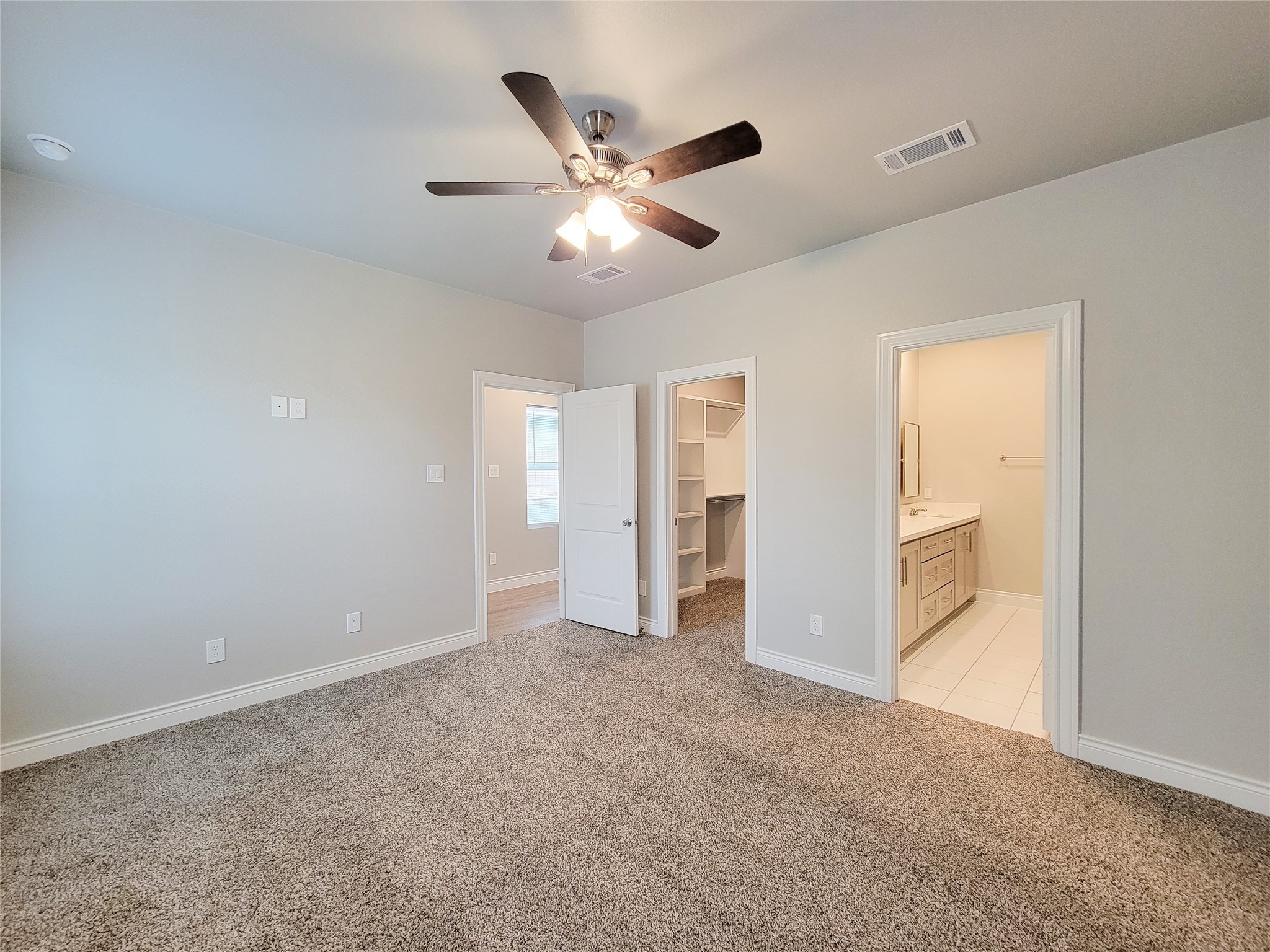 216 West Live Oak Street Angleton, TX 77515 - Photo 17 of 40 wooden floor in an empty room and a ceiling fan