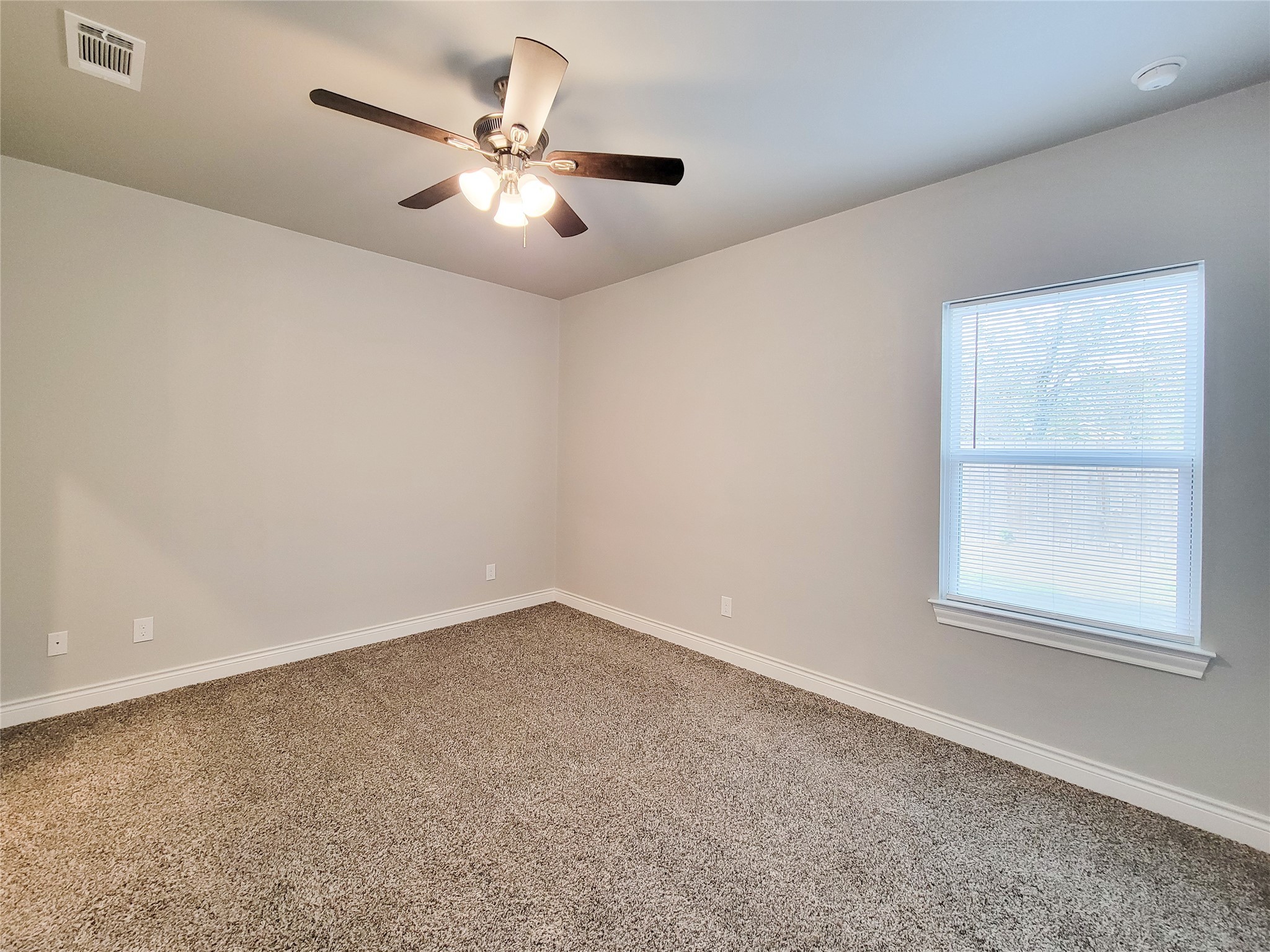 216 West Live Oak Street Angleton, TX 77515 - Photo 18 of 40 an empty room with windows and fan