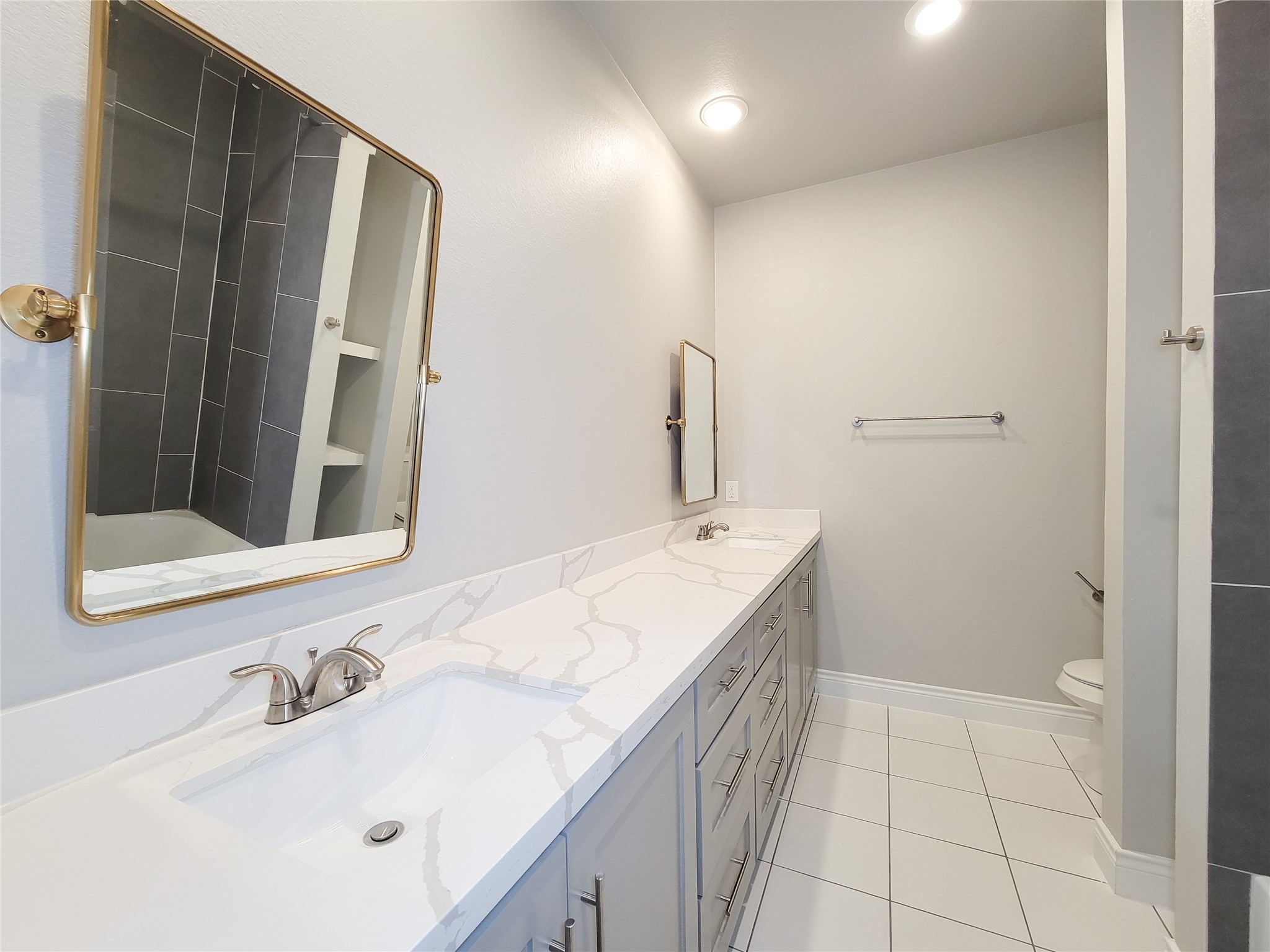 216 West Live Oak Street Angleton, TX 77515 - Photo 19 of 40 a bathroom with a sink and a mirror