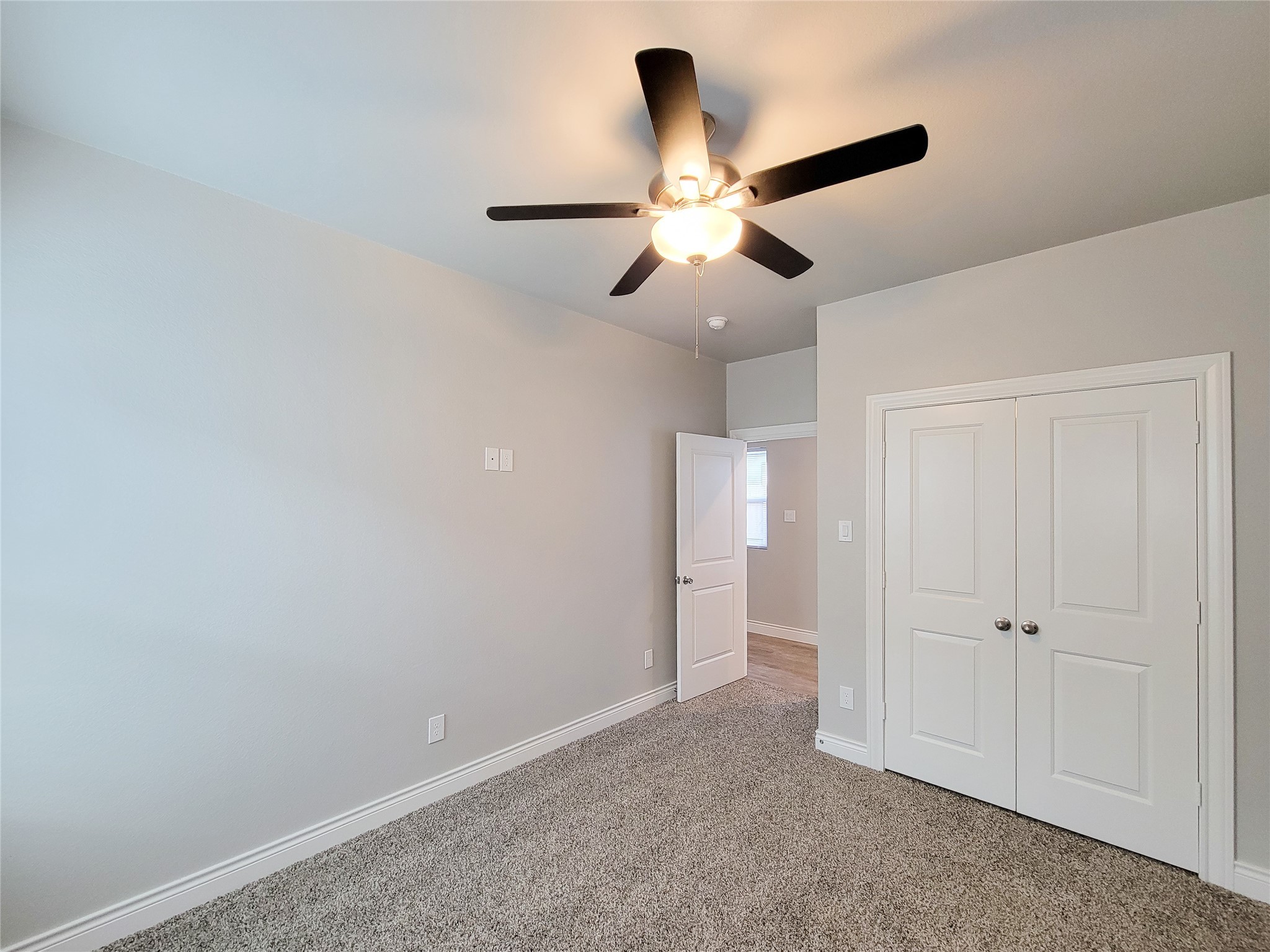 216 West Live Oak Street Angleton, TX 77515 - Photo 23 of 40 an empty room with closet and a chandelier fan
