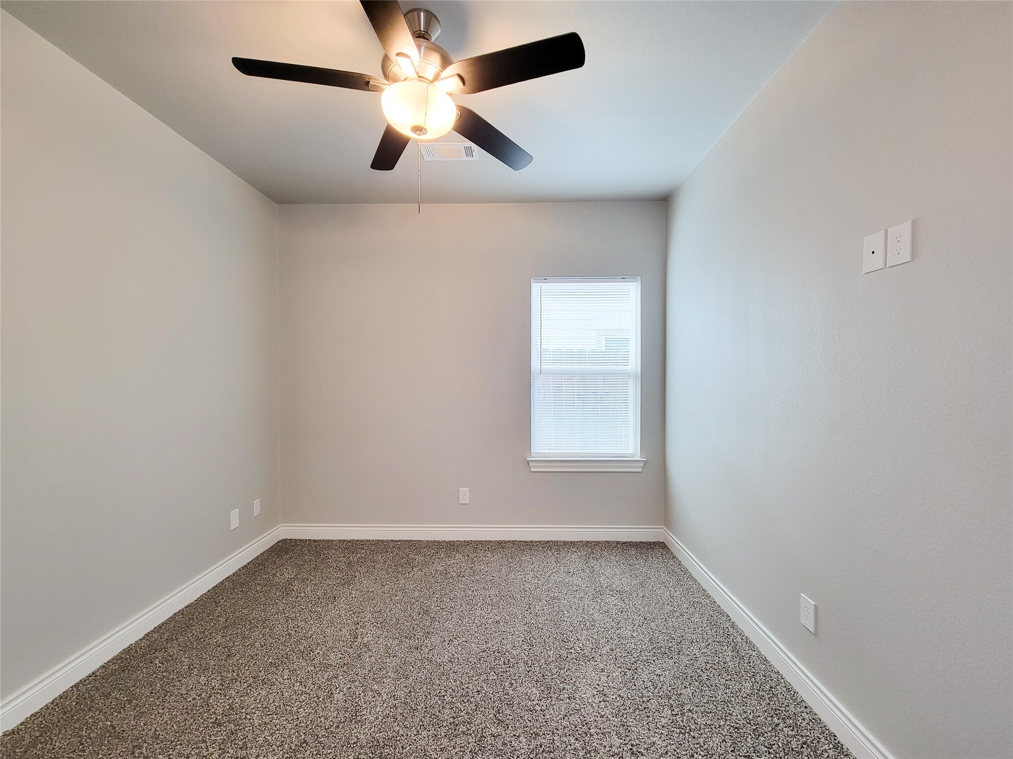 216 West Live Oak Street Angleton, TX 77515 - Photo 24 of 40 an empty room with a window and a fan