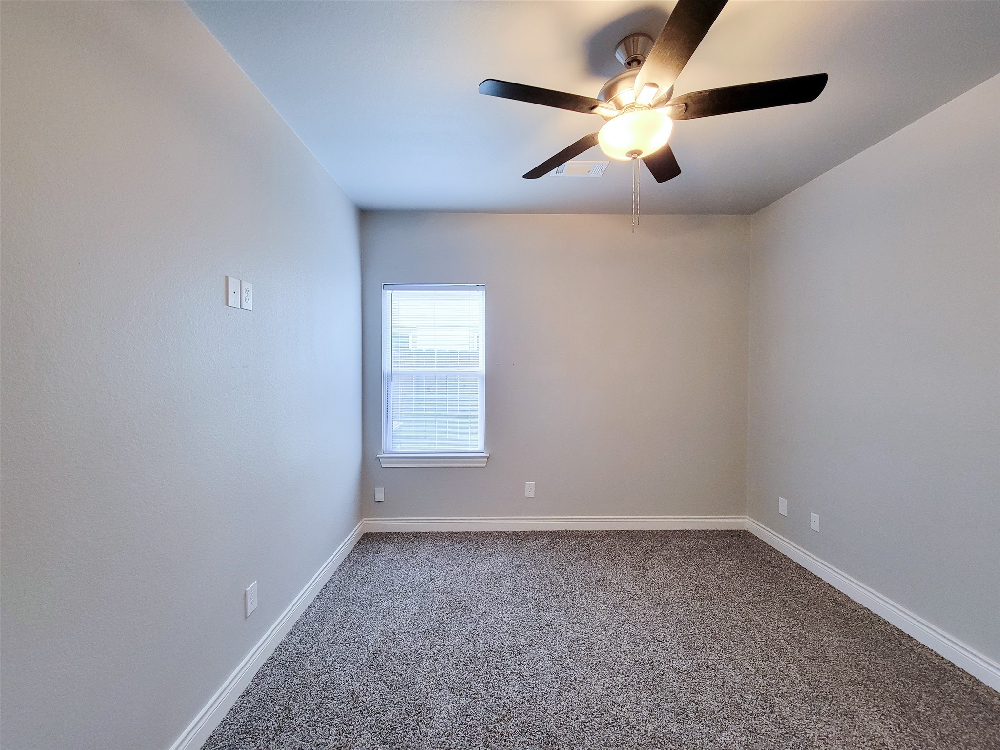216 West Live Oak Street Angleton, TX 77515 - Photo 26 of 40 an empty room with chandelier fan and windows