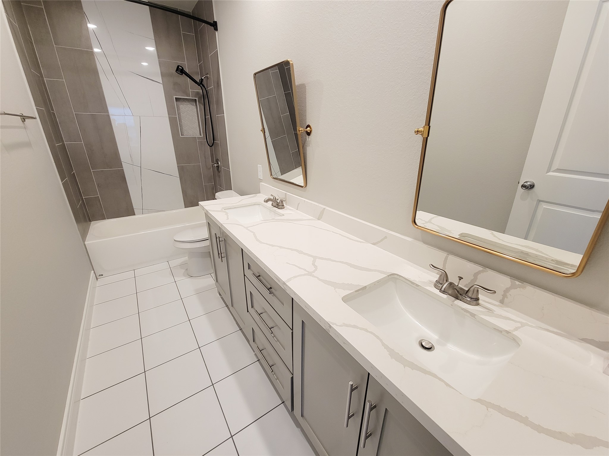 216 West Live Oak Street Angleton, TX 77515 - Photo 28 of 40 a spacious bathroom with a double vanity sink a mirror and a bathtub