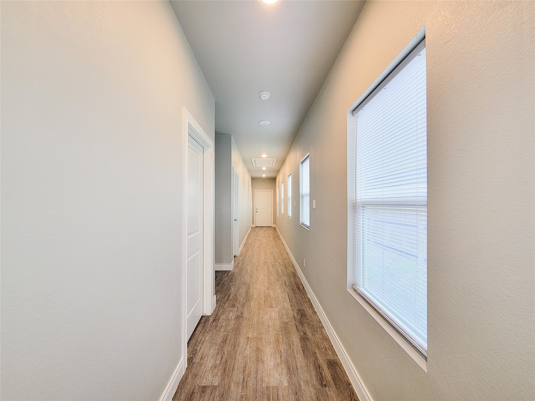 216 West Live Oak Street Angleton, TX 77515 - Photo 32 of 40 a view of a hallway with wooden floor and staircase