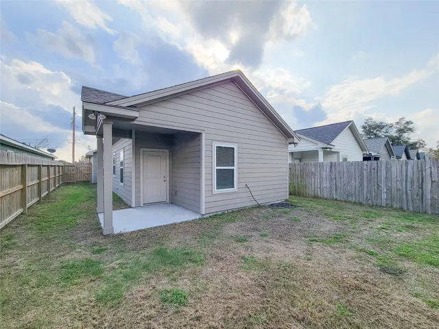 a view of a backyard with wooden fence