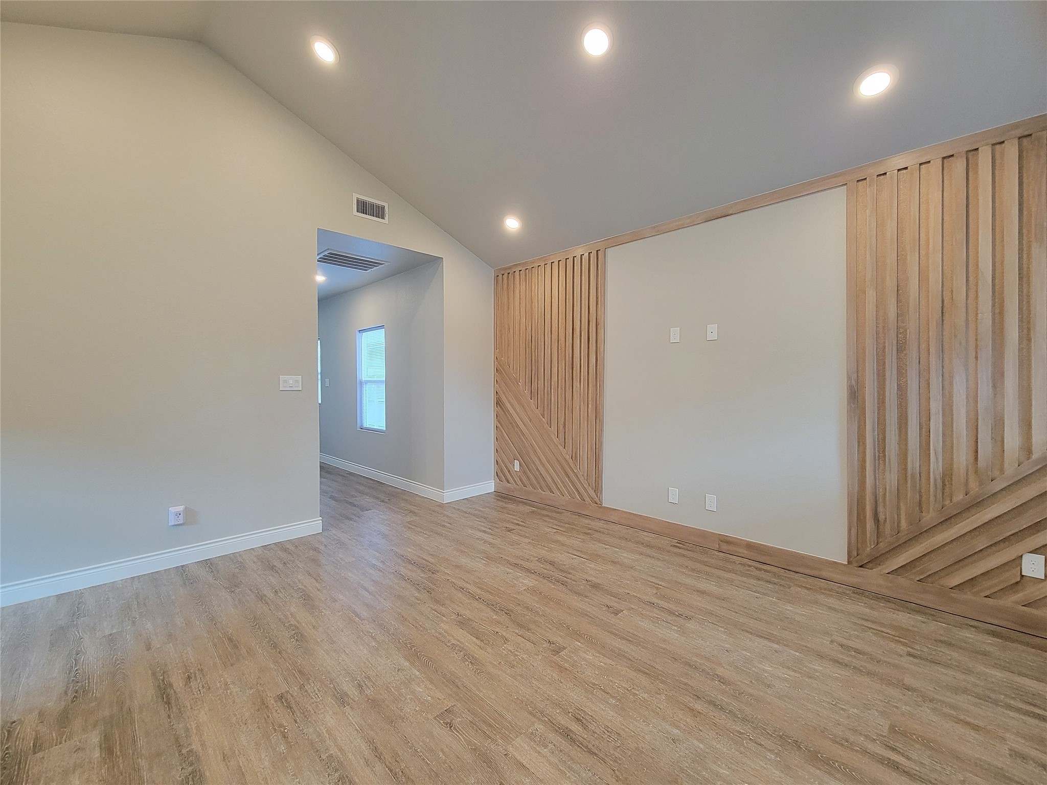 216 West Live Oak Street Angleton, TX 77515 - Photo 5 of 40 an empty room with wooden floor and windows