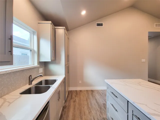 a kitchen with a sink and refrigerator