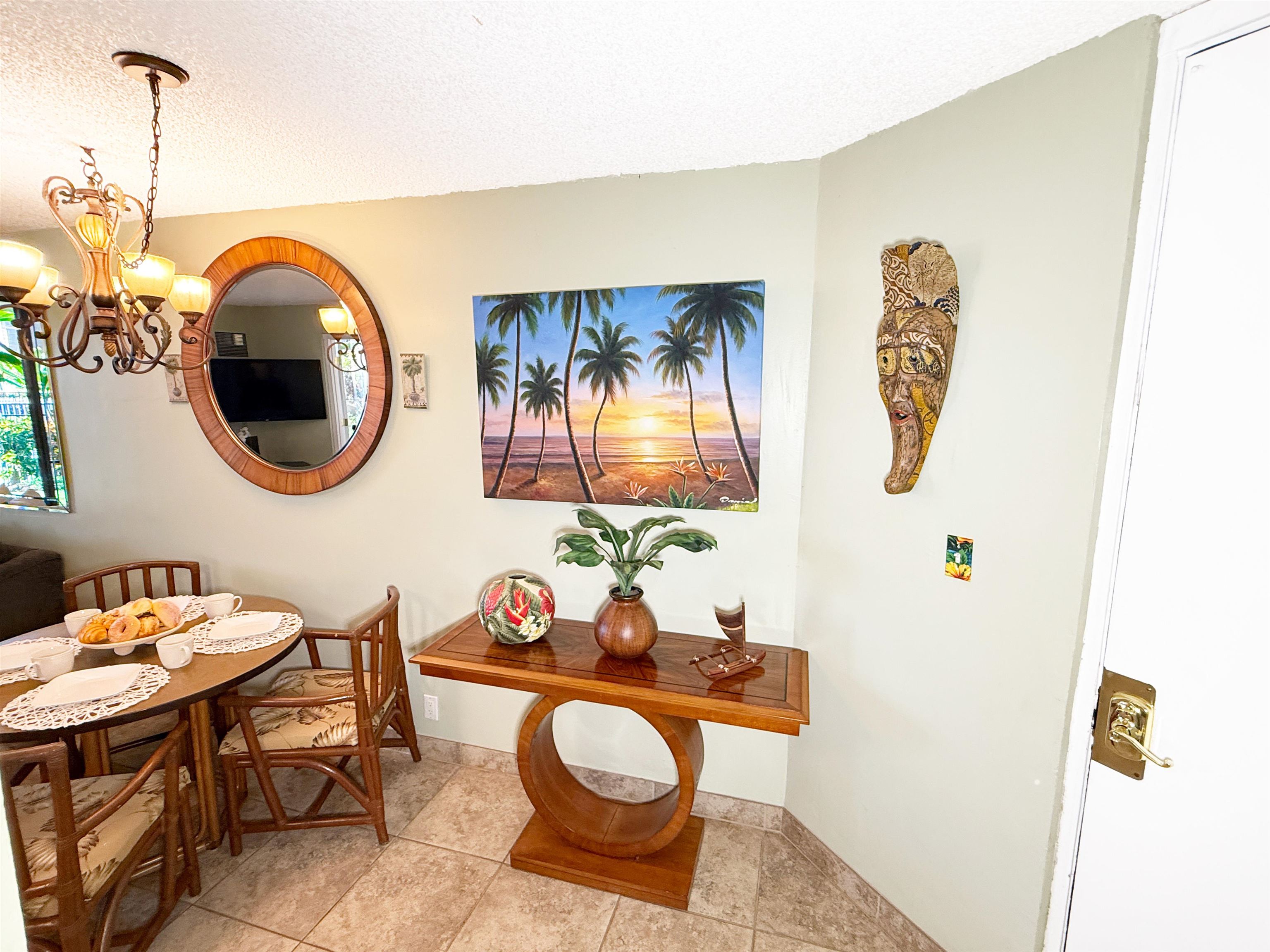 938 South Kihei Road, Unit 109 Kihei, HI 96753 - Photo 12 of 30 a view of a dining room with furniture and chandelier
