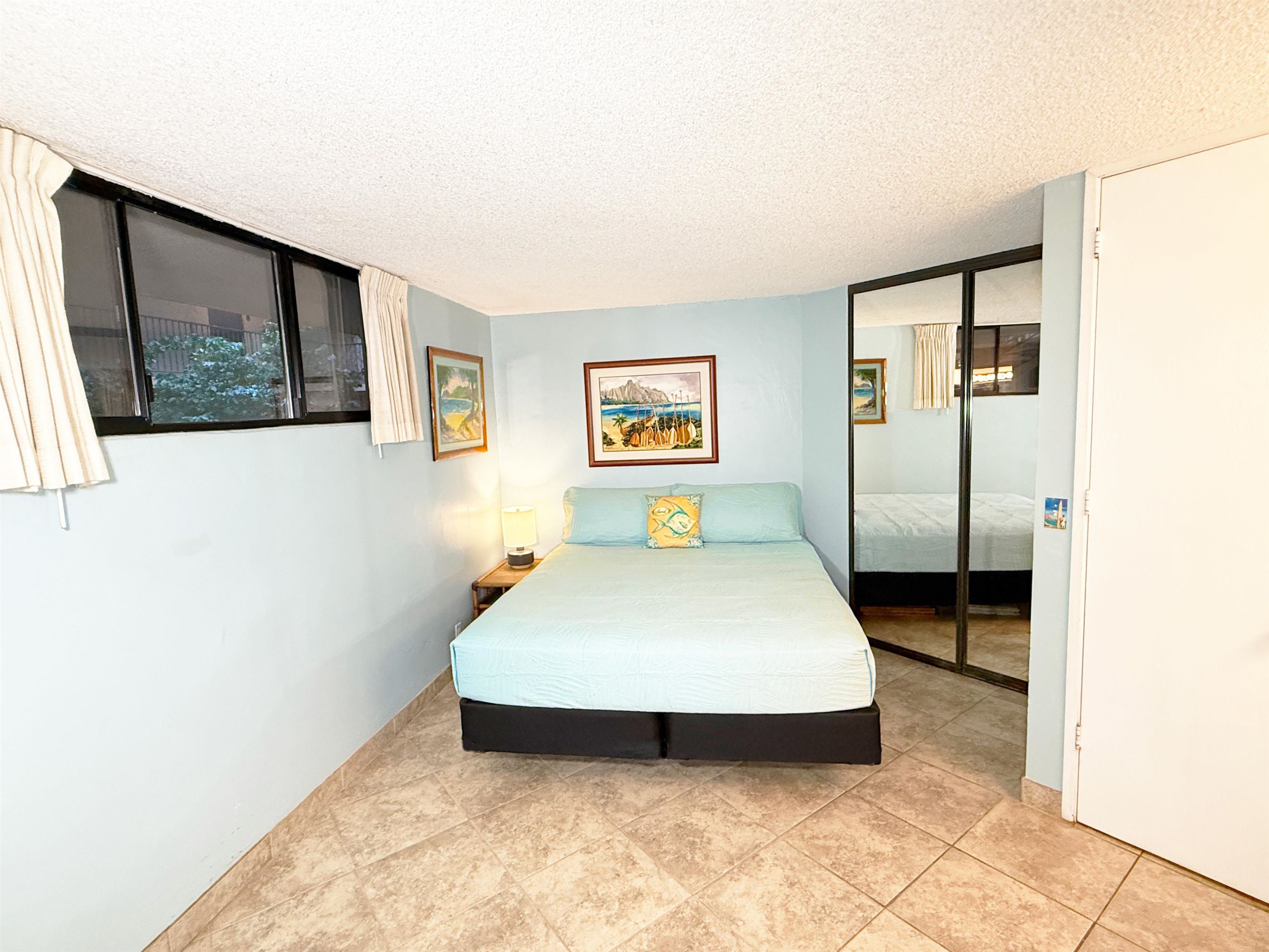 938 South Kihei Road, Unit 109 Kihei, HI 96753 - Photo 15 of 30 a bedroom with a bed and wall painting