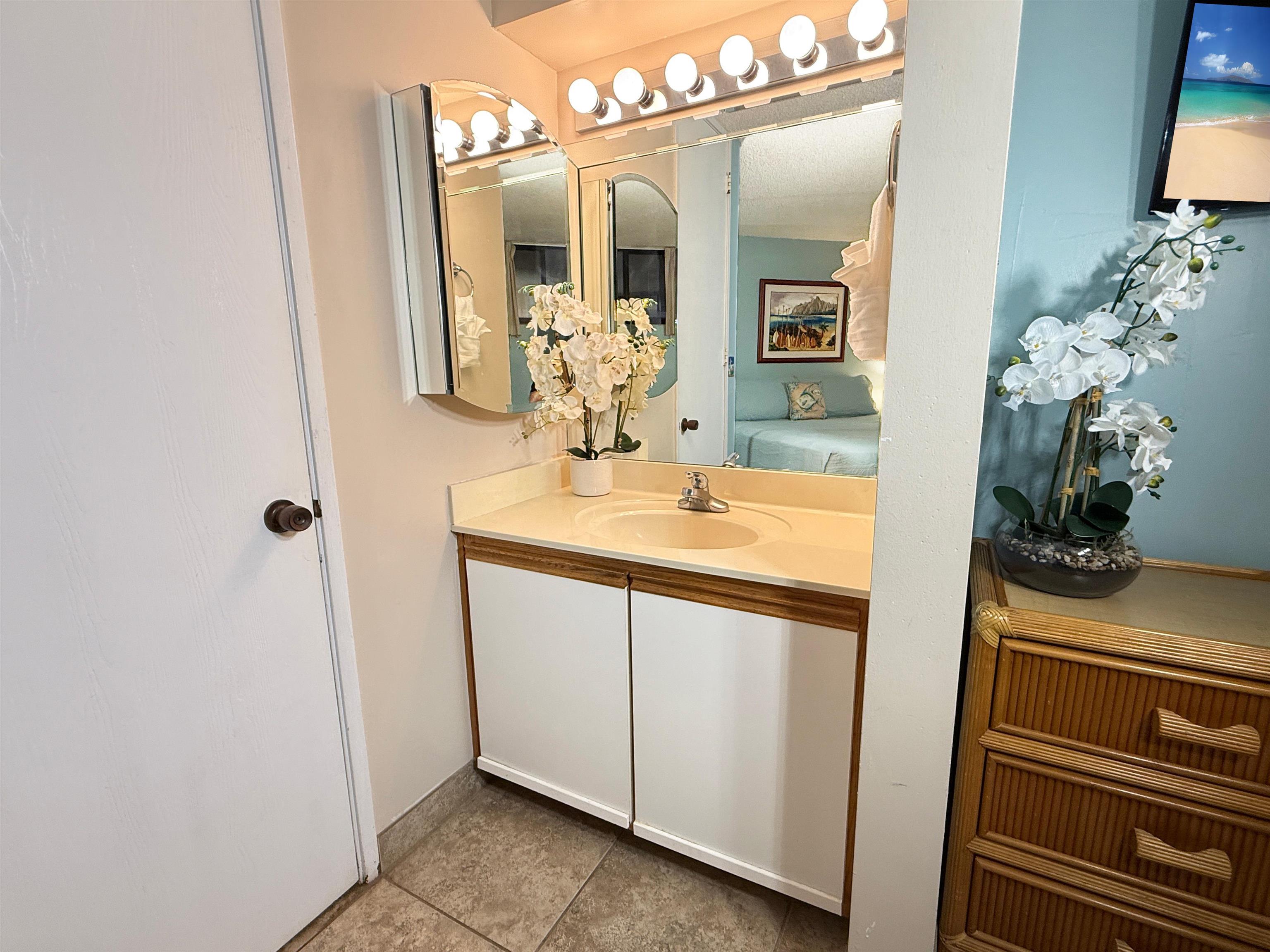 938 South Kihei Road, Unit 109 Kihei, HI 96753 - Photo 17 of 30 a bathroom with a sink and a mirror