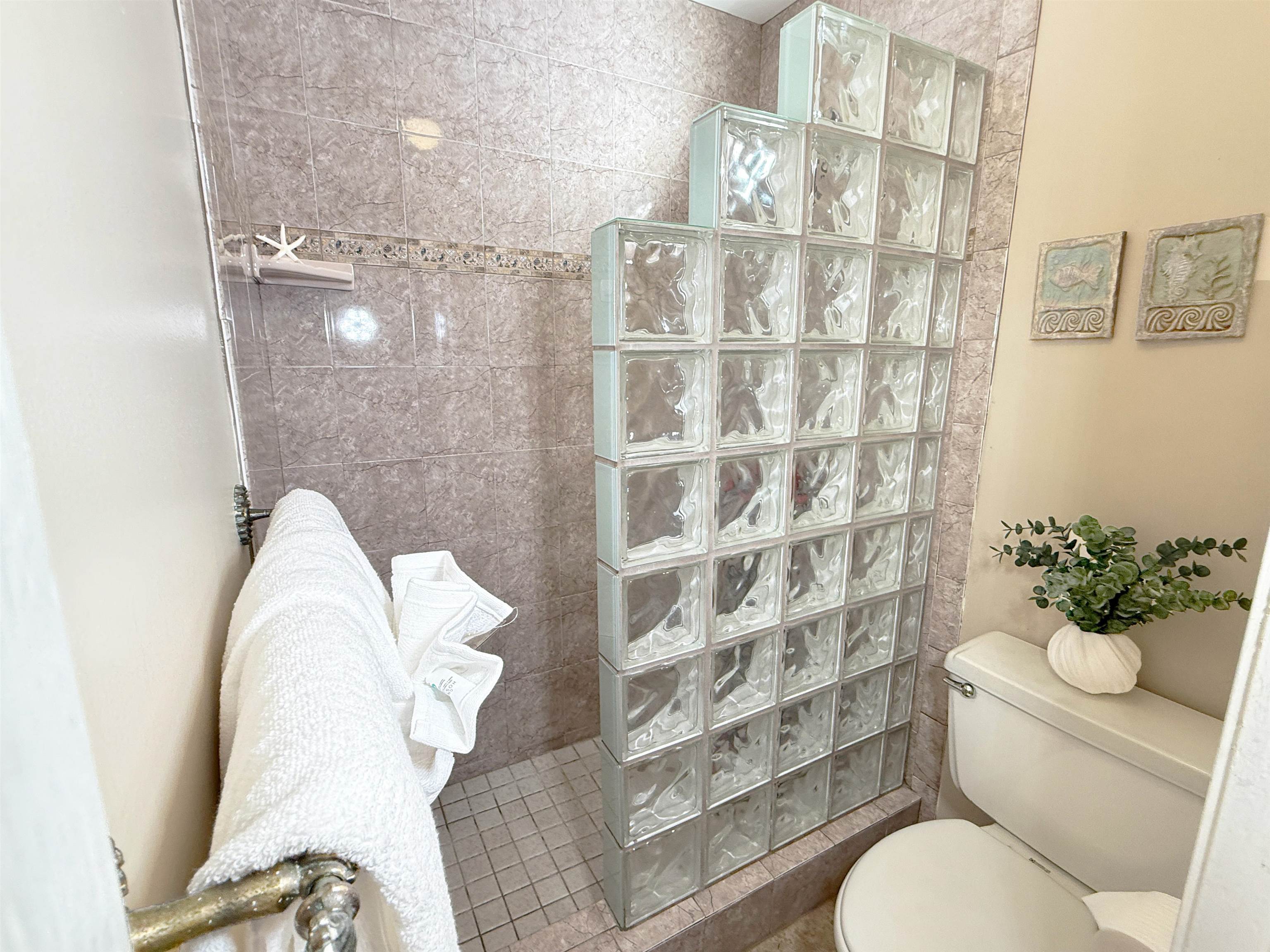 938 South Kihei Road, Unit 109 Kihei, HI 96753 - Photo 18 of 30 a bathroom with a toilet and a shower curtain