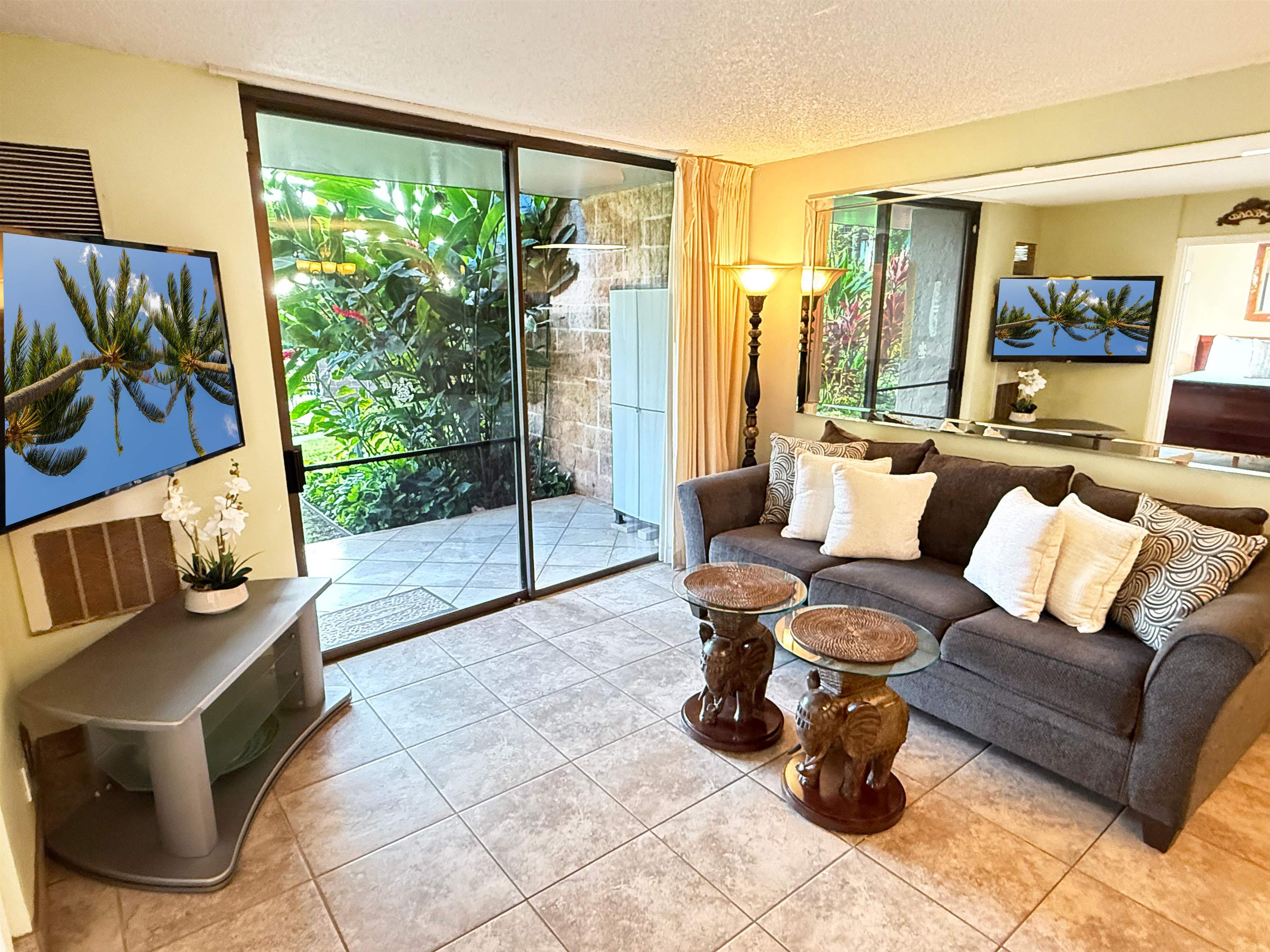 938 South Kihei Road, Unit 109 Kihei, HI 96753 - Photo 2 of 30 a living room with furniture and a large window