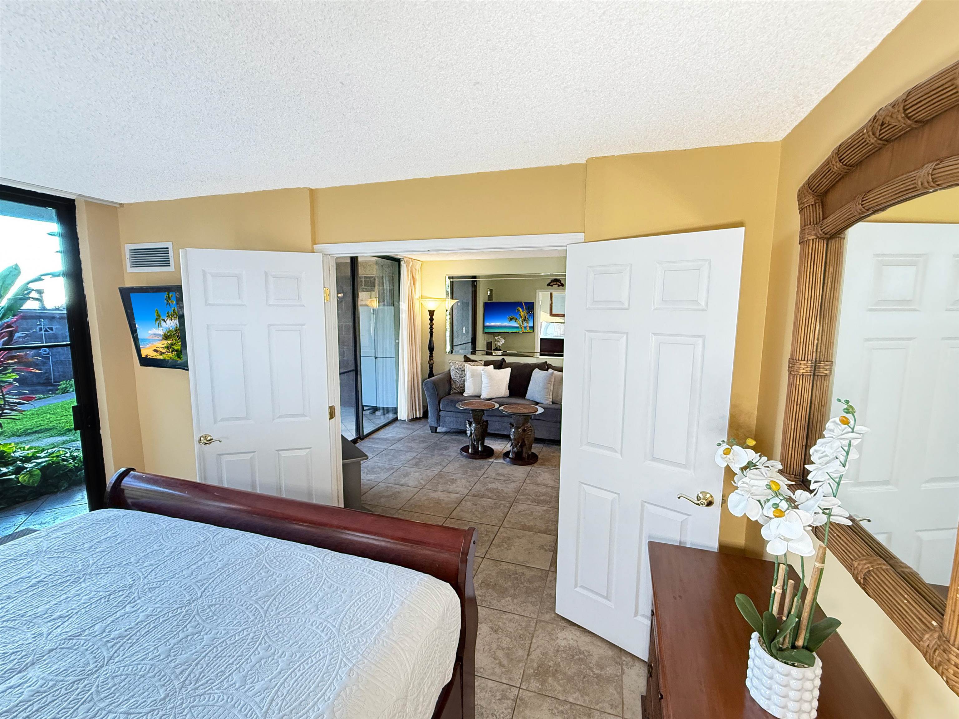 938 South Kihei Road, Unit 109 Kihei, HI 96753 - Photo 4 of 30 a bedroom with a bed a couch and potted plant