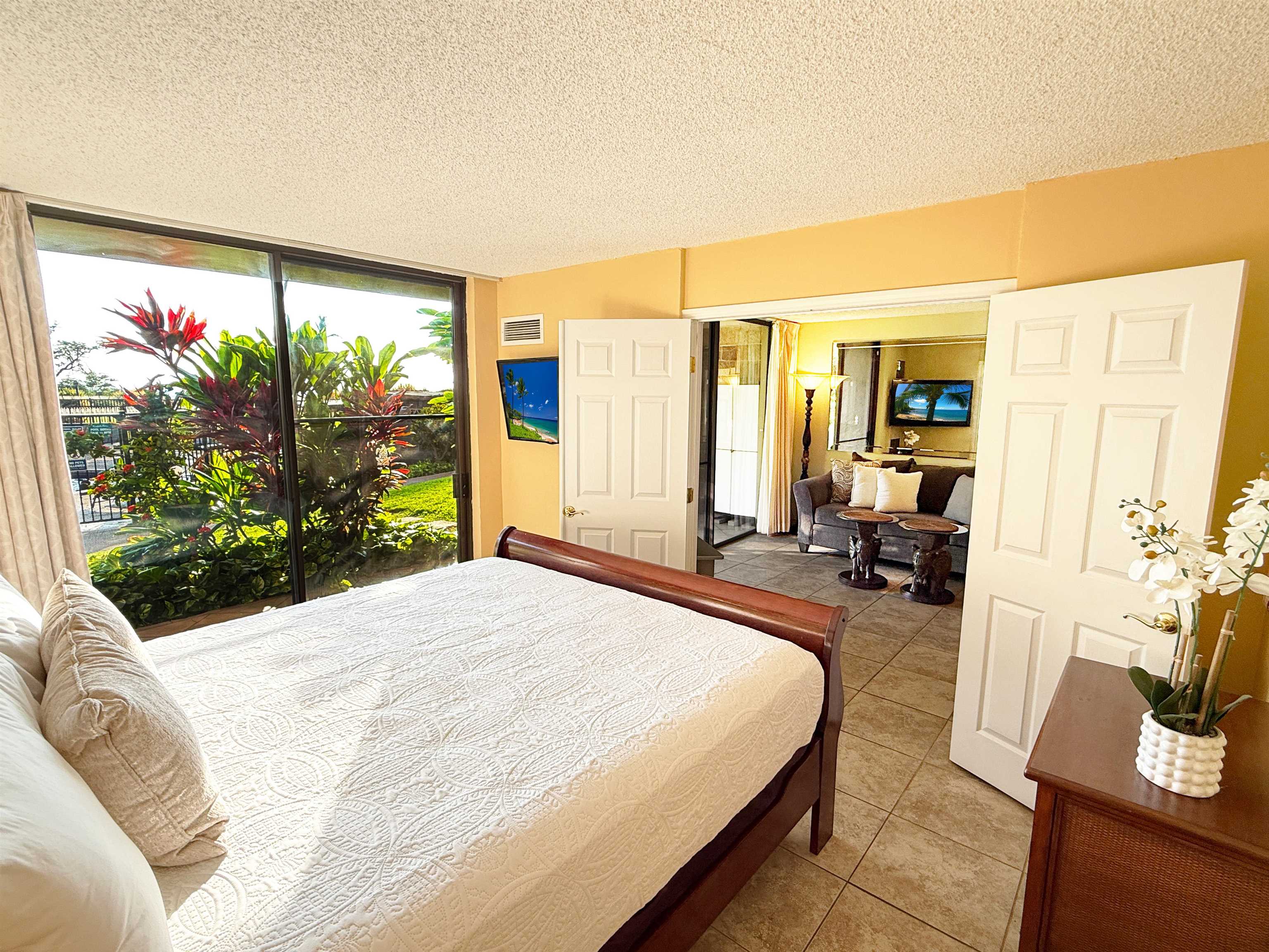 938 South Kihei Road, Unit 109 Kihei, HI 96753 - Photo 5 of 30 a bedroom with a bed and large windows