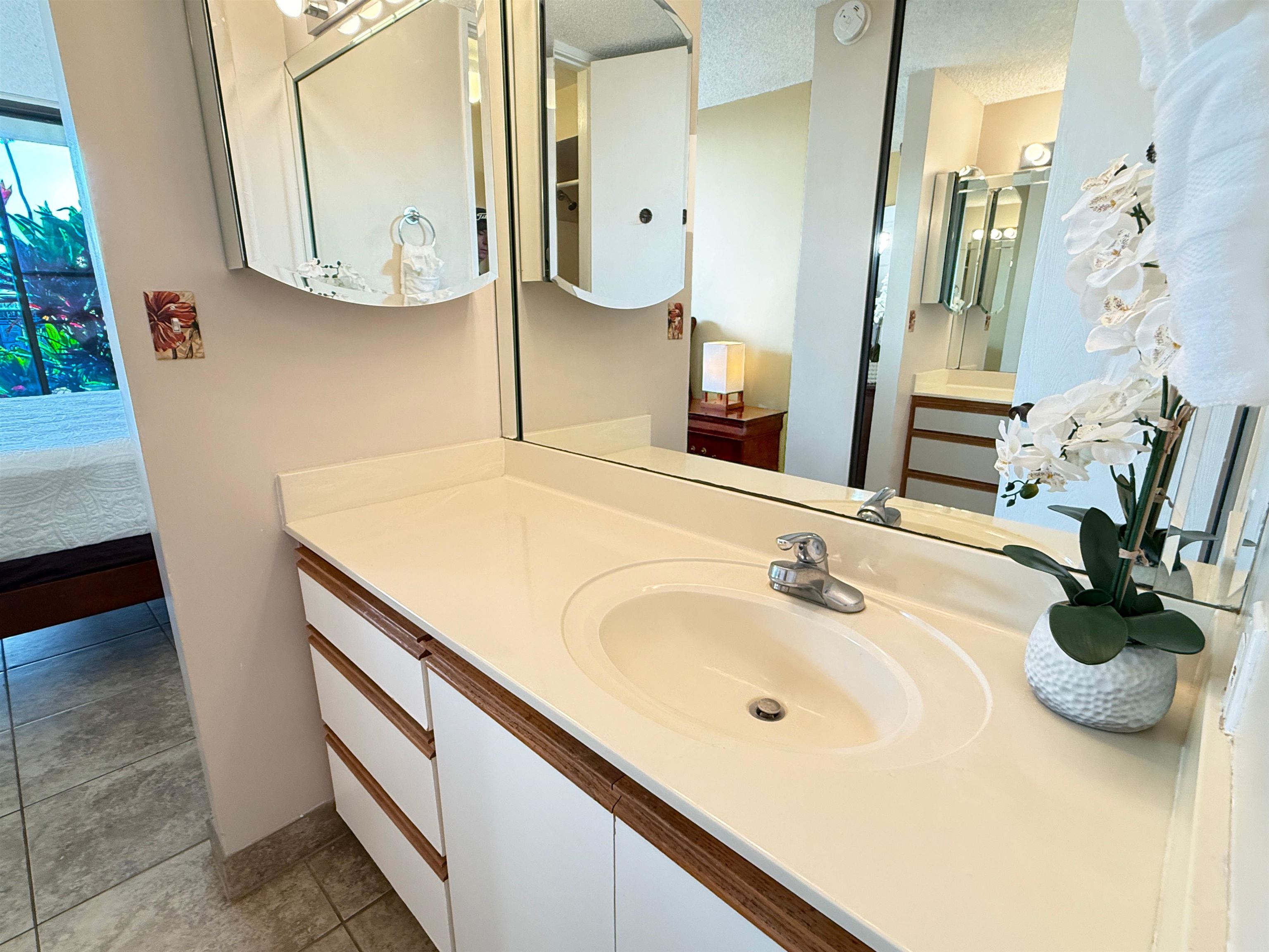 938 South Kihei Road, Unit 109 Kihei, HI 96753 - Photo 10 of 30 a bathroom with a sink and a mirror