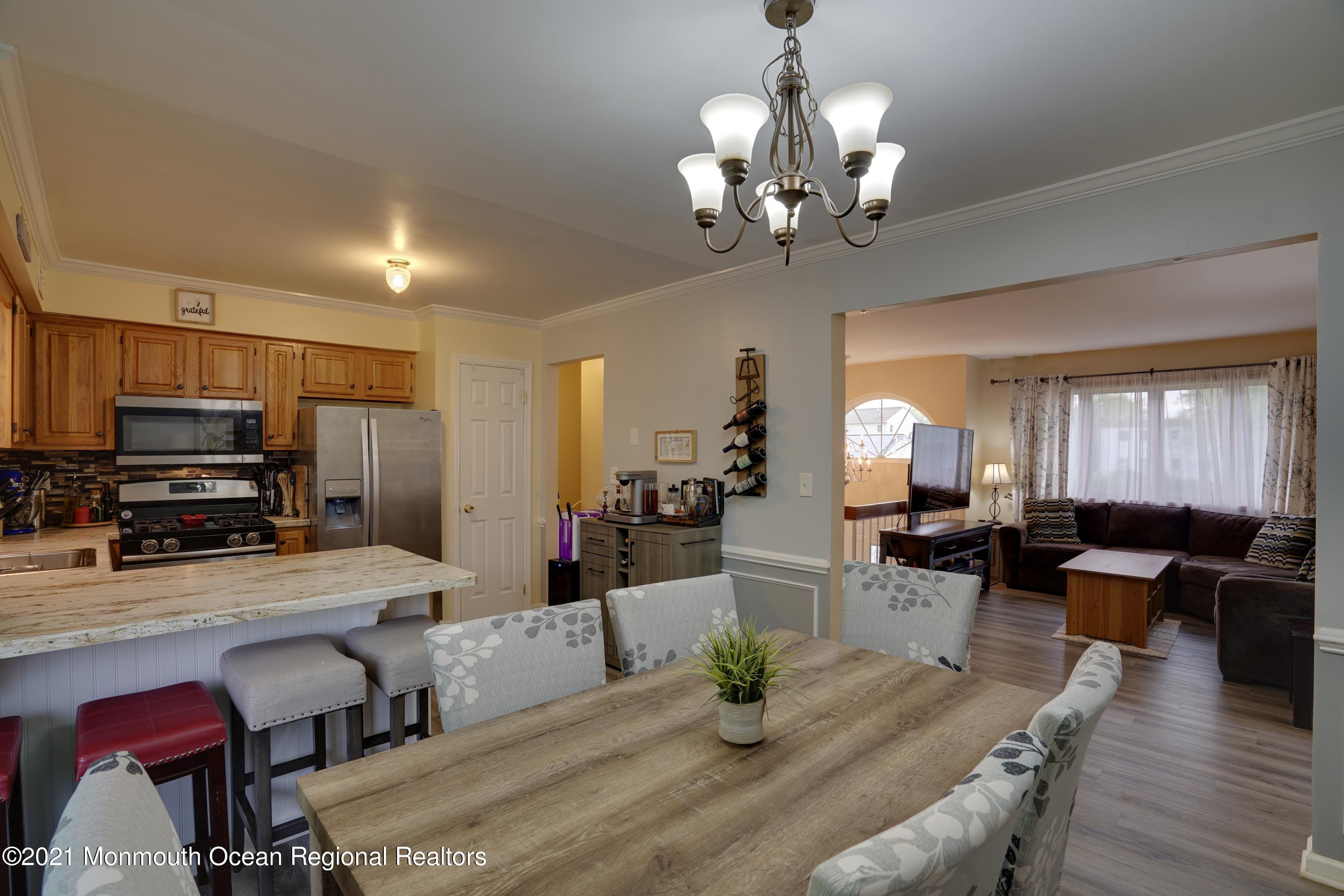 217 County Road Cliffwood, NJ 07721 - Photo 8 of 27 a view of a dining room with furniture a chandelier and wooden floor