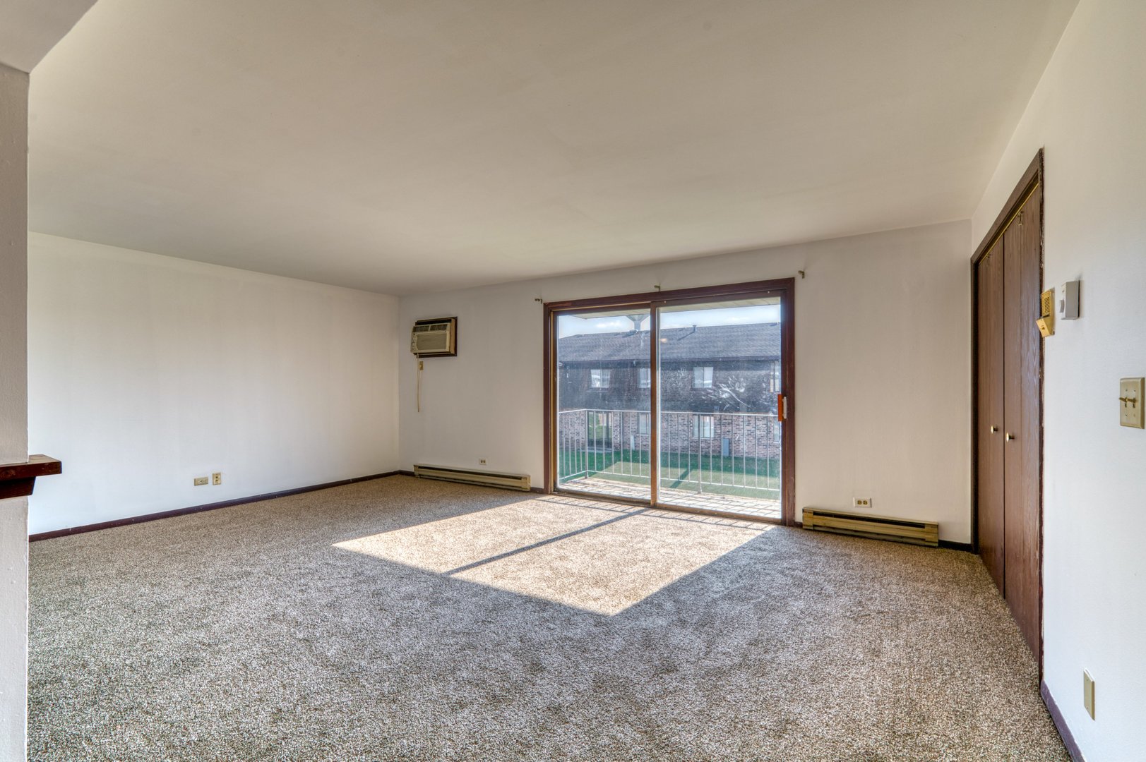 1713 Nelson Road, Unit 12 New Lenox, IL 60451 - Photo 4 of 14 an empty room with sliding door