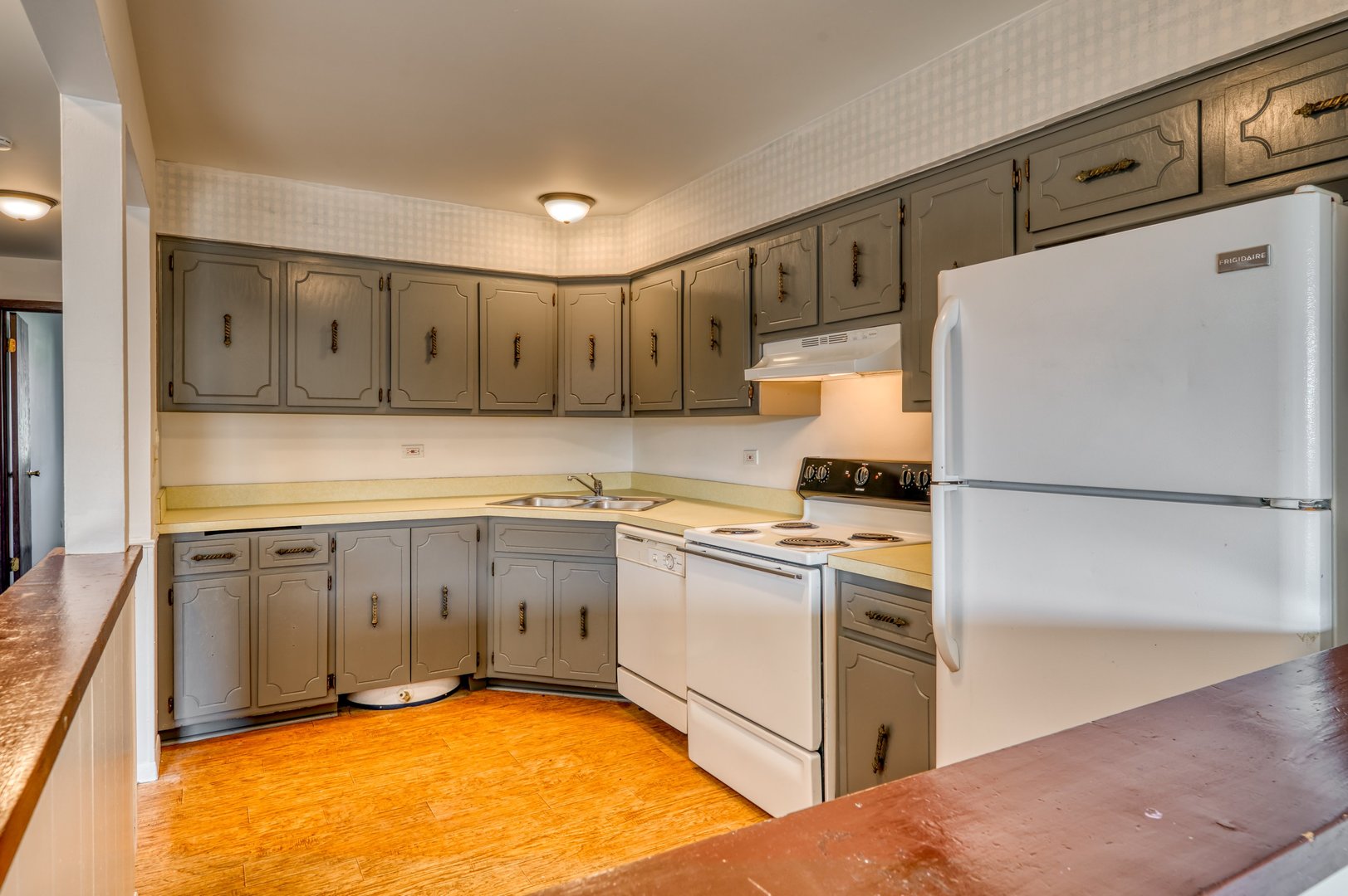 1713 Nelson Road, Unit 12 New Lenox, IL 60451 - Photo 7 of 14 a kitchen with a refrigerator sink stove and cabinets