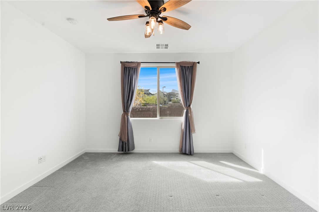 633 Infinity Rdg Street Las Vegas, NV 89138 - Photo 8 of 30 Carpeted spare room with a ceiling fan and baseboards