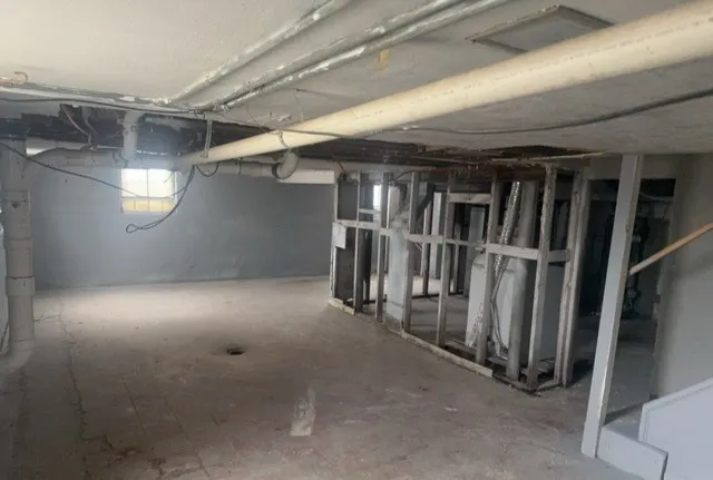 a view of an empty room and a window