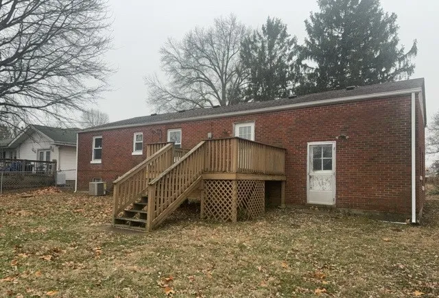 a view of a house with a yard covered in snow