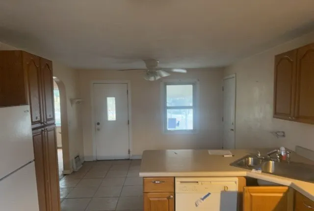 a view of a kitchen with refrigerator and cabinet