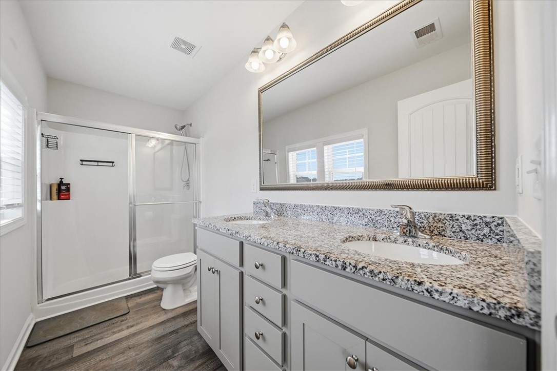 403 Seaborn Circle Pendleton, SC 29670 - Photo 29 of 47 This primary bathroom showcases a double vanity with ample storage and a spacious glass-enclosed shower.