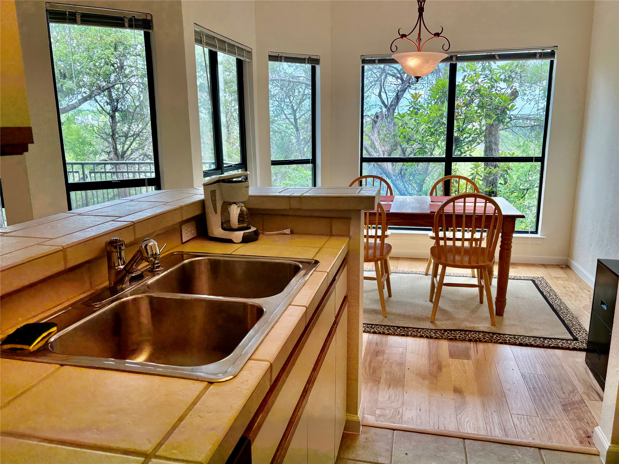 4711 Spicewood Springs Road, Unit 8146 Austin, TX 78759 - Photo 2 of 14 Kitchen with tile counters, decorative light fixtures, and light wood finished floors