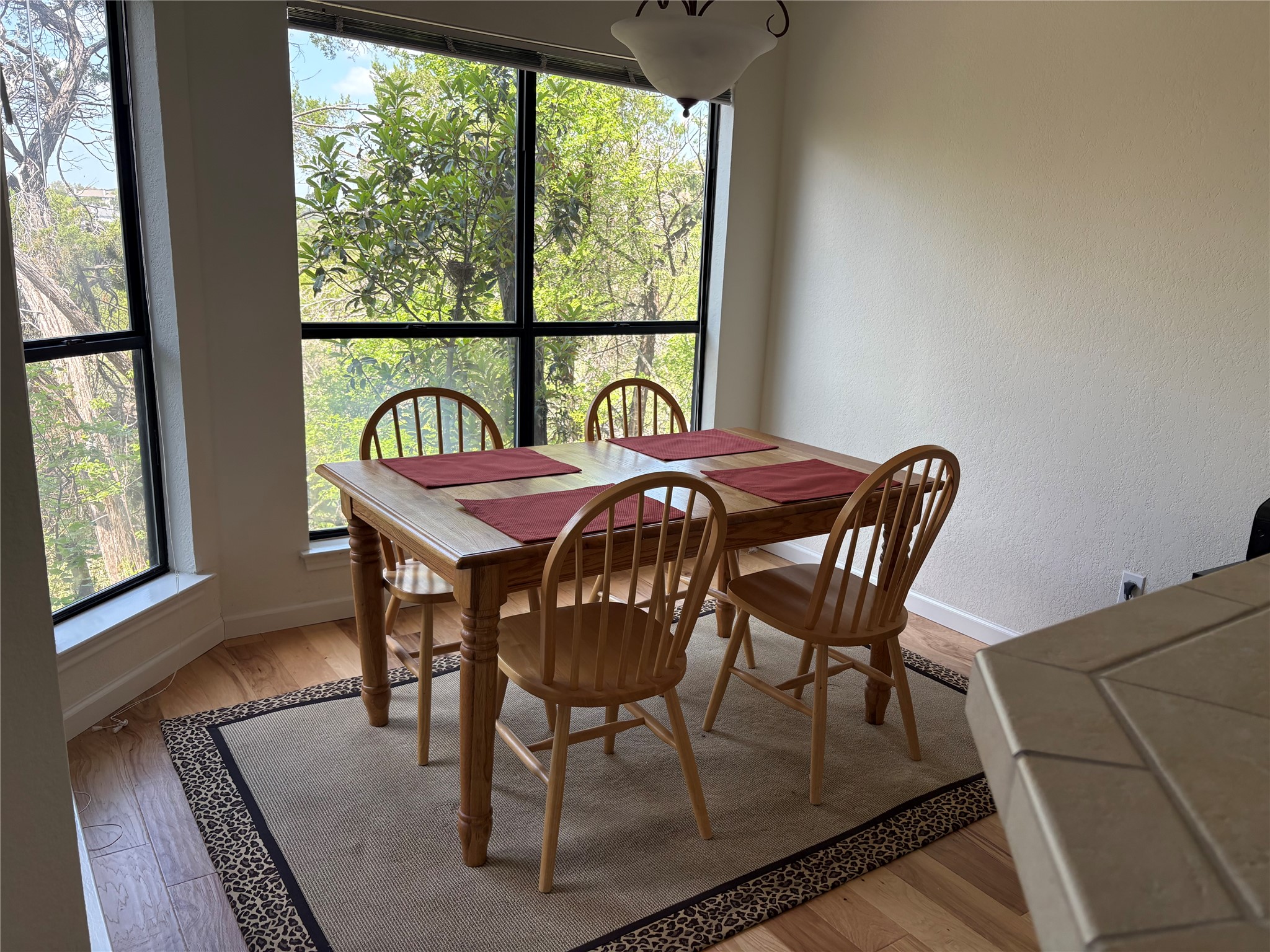 4711 Spicewood Springs Road, Unit 8146 Austin, TX 78759 - Photo 3 of 14 Dining room featuring light wood-style flooring and a textured wall