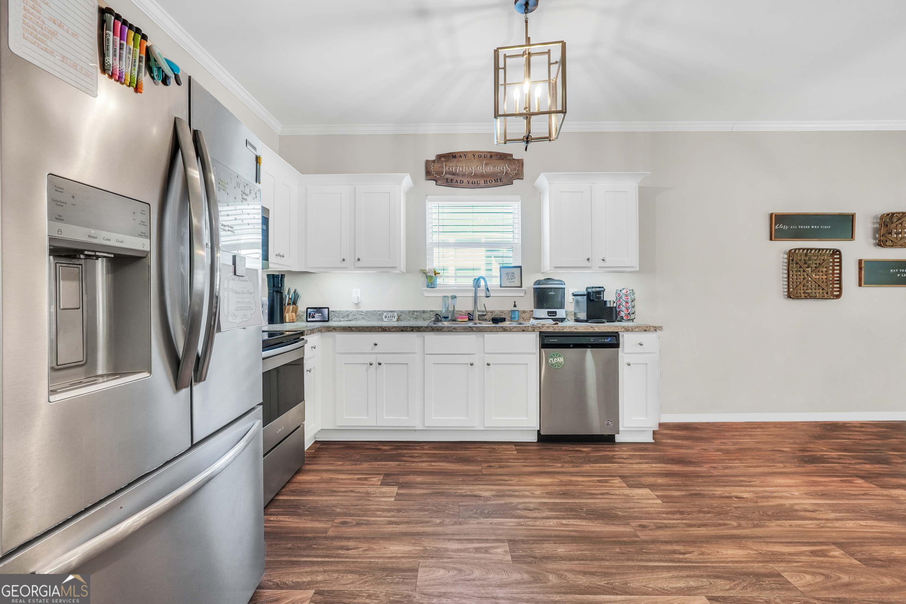 117 Charleston Lane Milner, GA 30257 - Photo 11 of 34 a kitchen with granite countertop white cabinets and white appliances