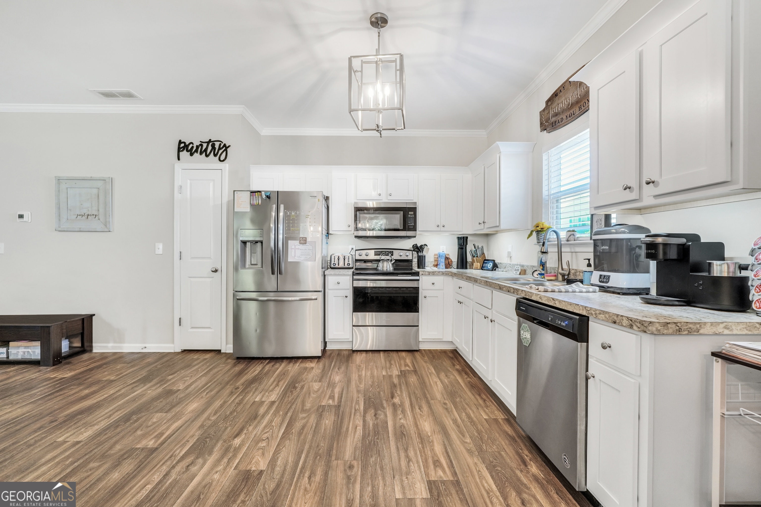 117 Charleston Lane Milner, GA 30257 - Photo 12 of 34 a kitchen with granite countertop a refrigerator oven a sink dishwasher and a stove with wooden floor