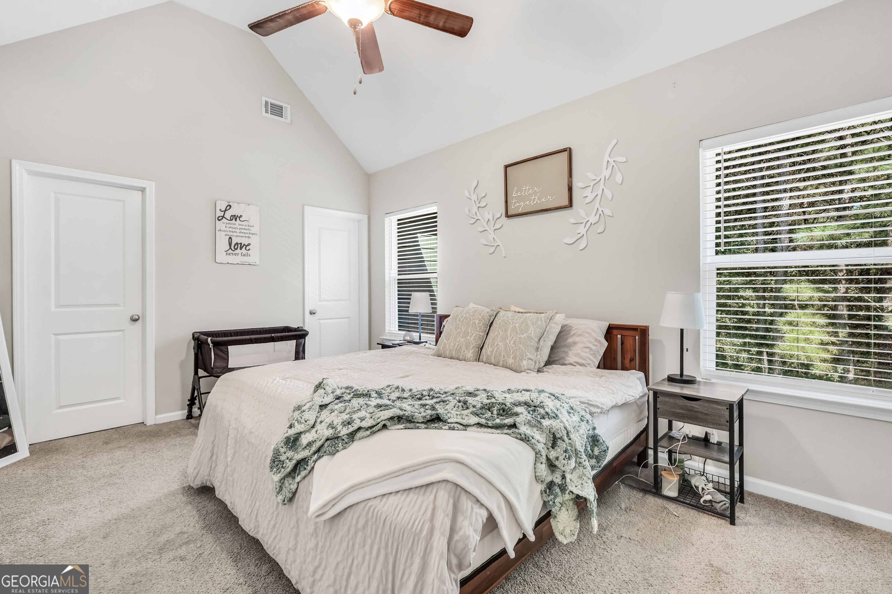 117 Charleston Lane Milner, GA 30257 - Photo 15 of 34 a bedroom with a bed and a chandelier