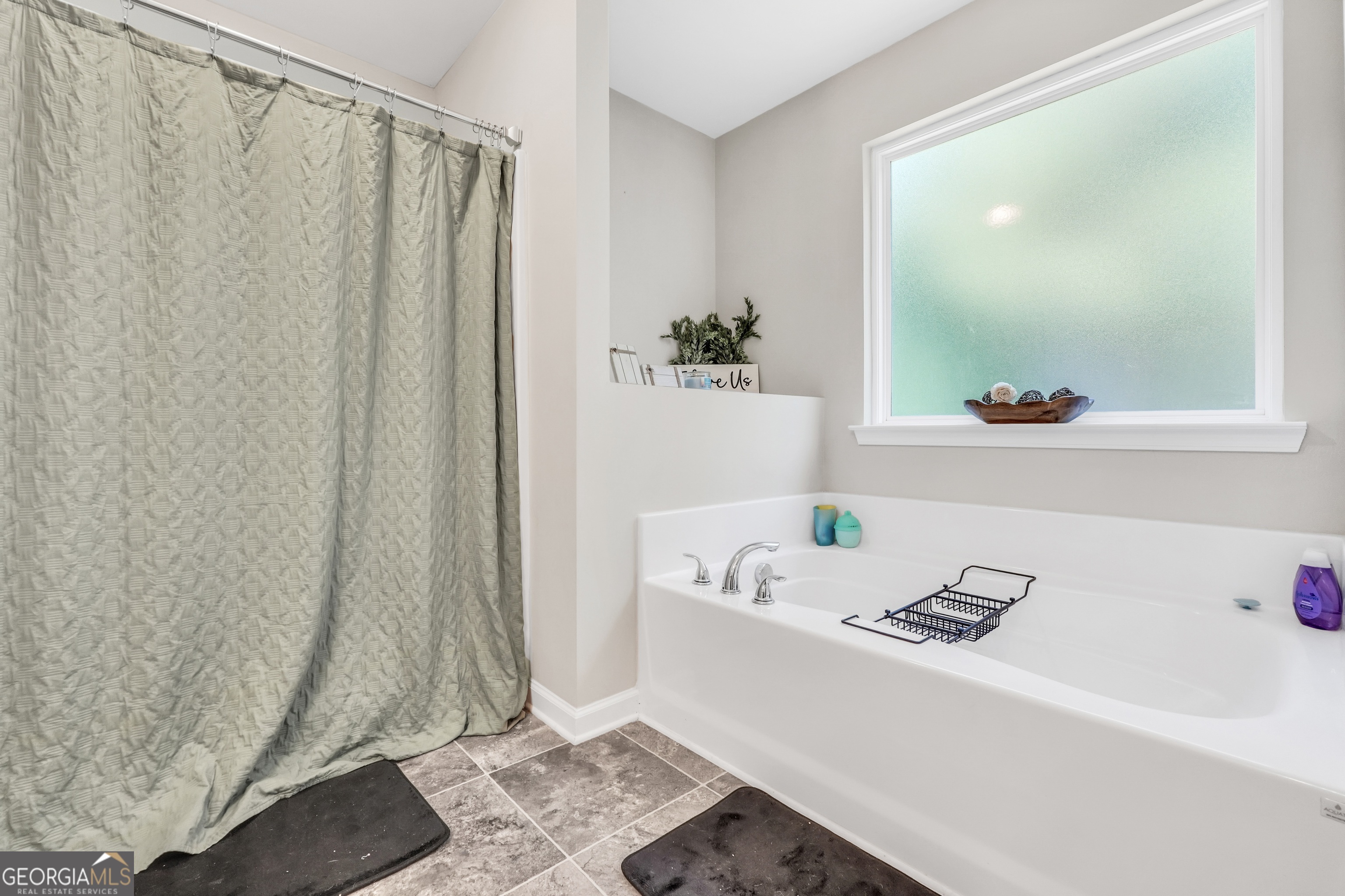 117 Charleston Lane Milner, GA 30257 - Photo 18 of 34 a bathroom with a bathtub and shower