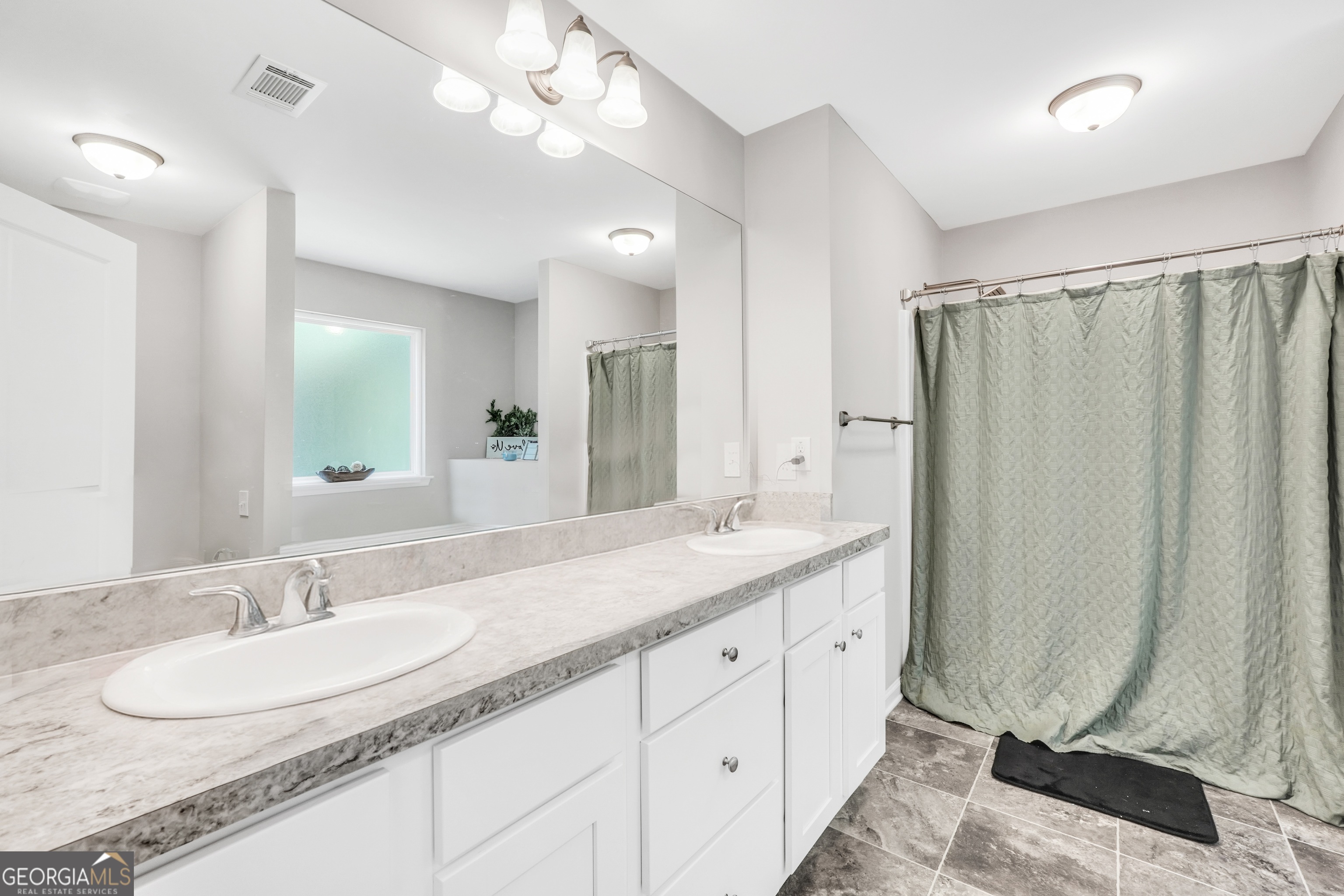 117 Charleston Lane Milner, GA 30257 - Photo 19 of 34 a bathroom with a double vanity sink mirror and double