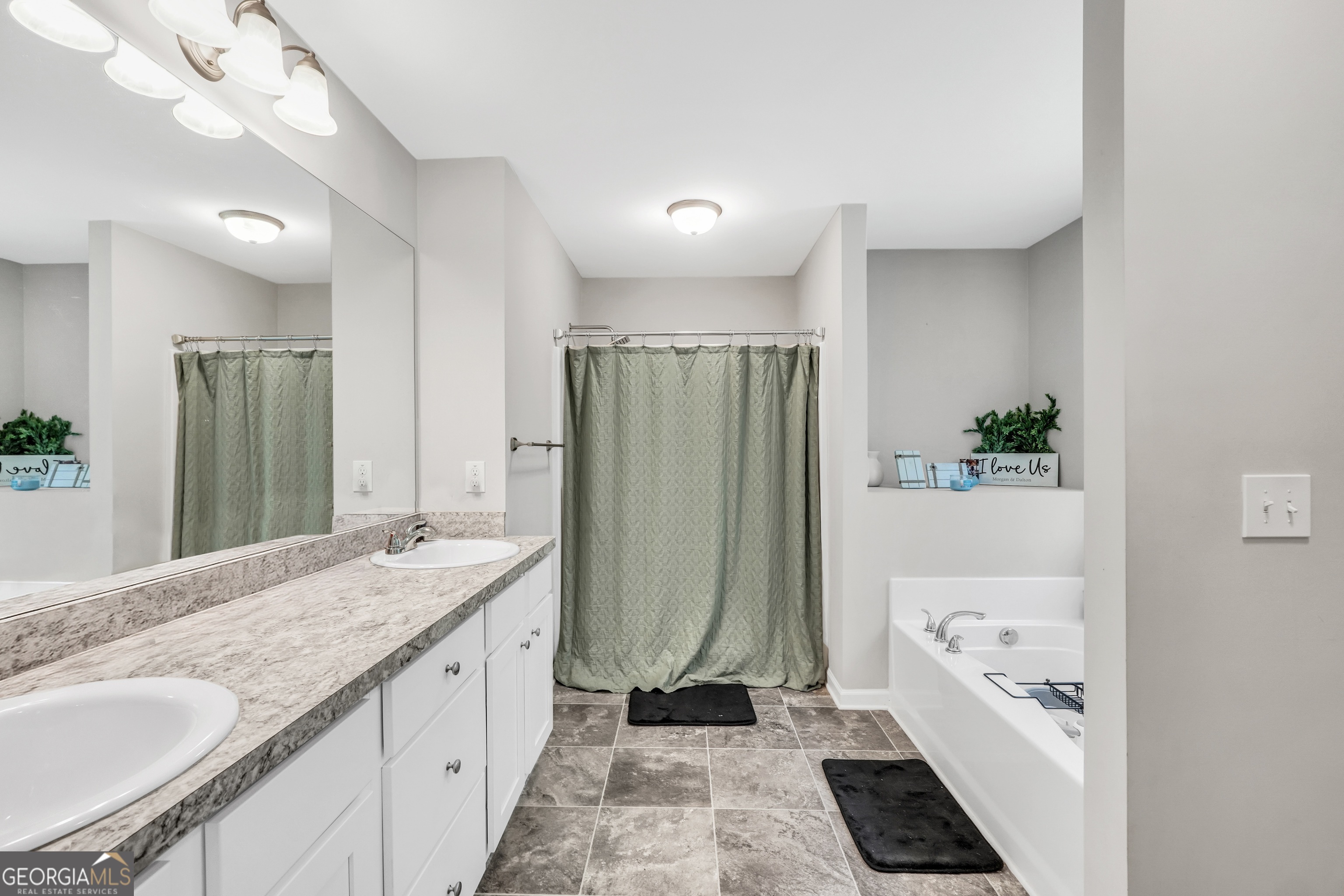 117 Charleston Lane Milner, GA 30257 - Photo 20 of 34 a bathroom with a granite countertop tub sink and mirror