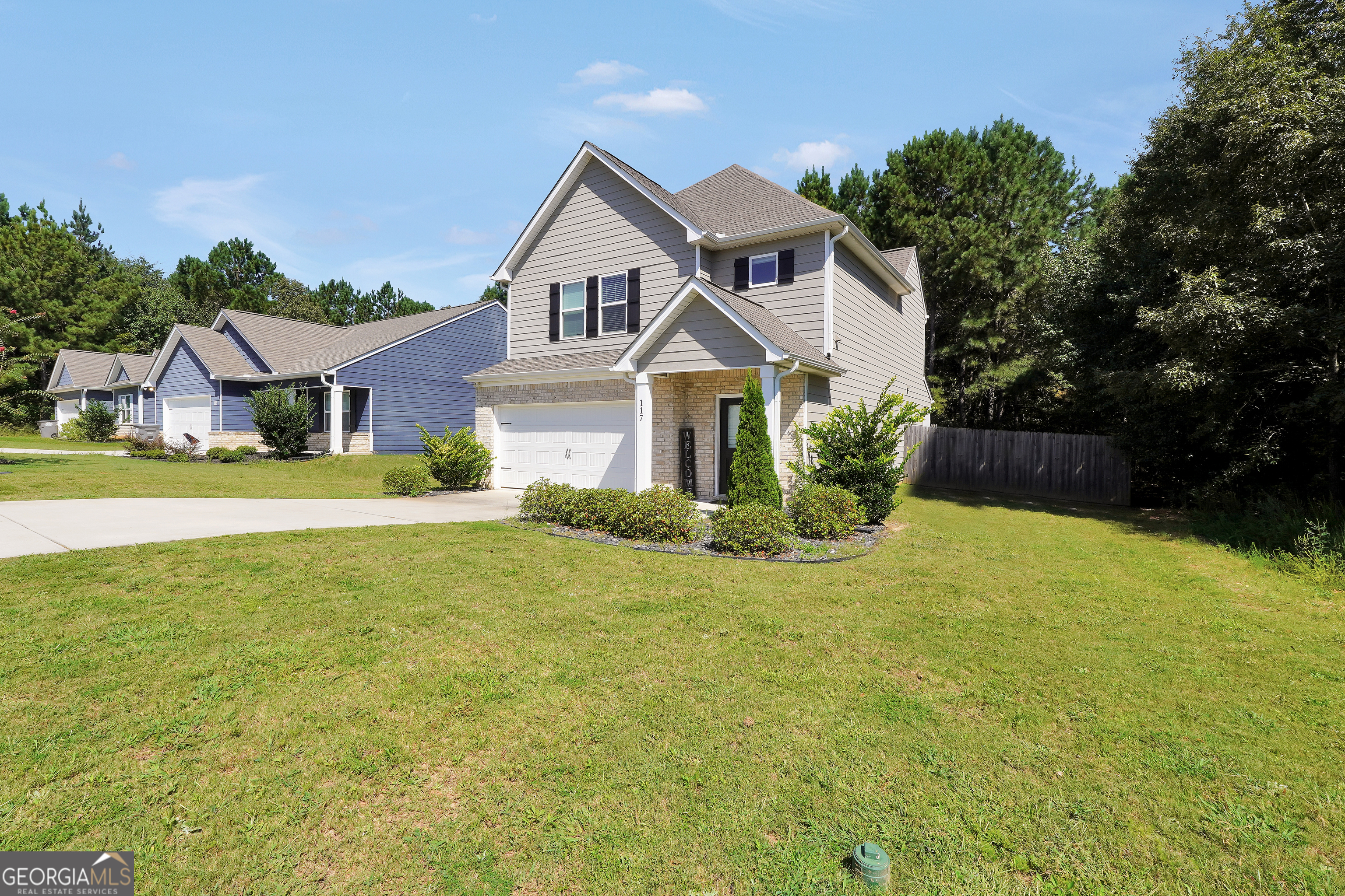 117 Charleston Lane Milner, GA 30257 - Photo 2 of 34 a front view of a house with yard and green space