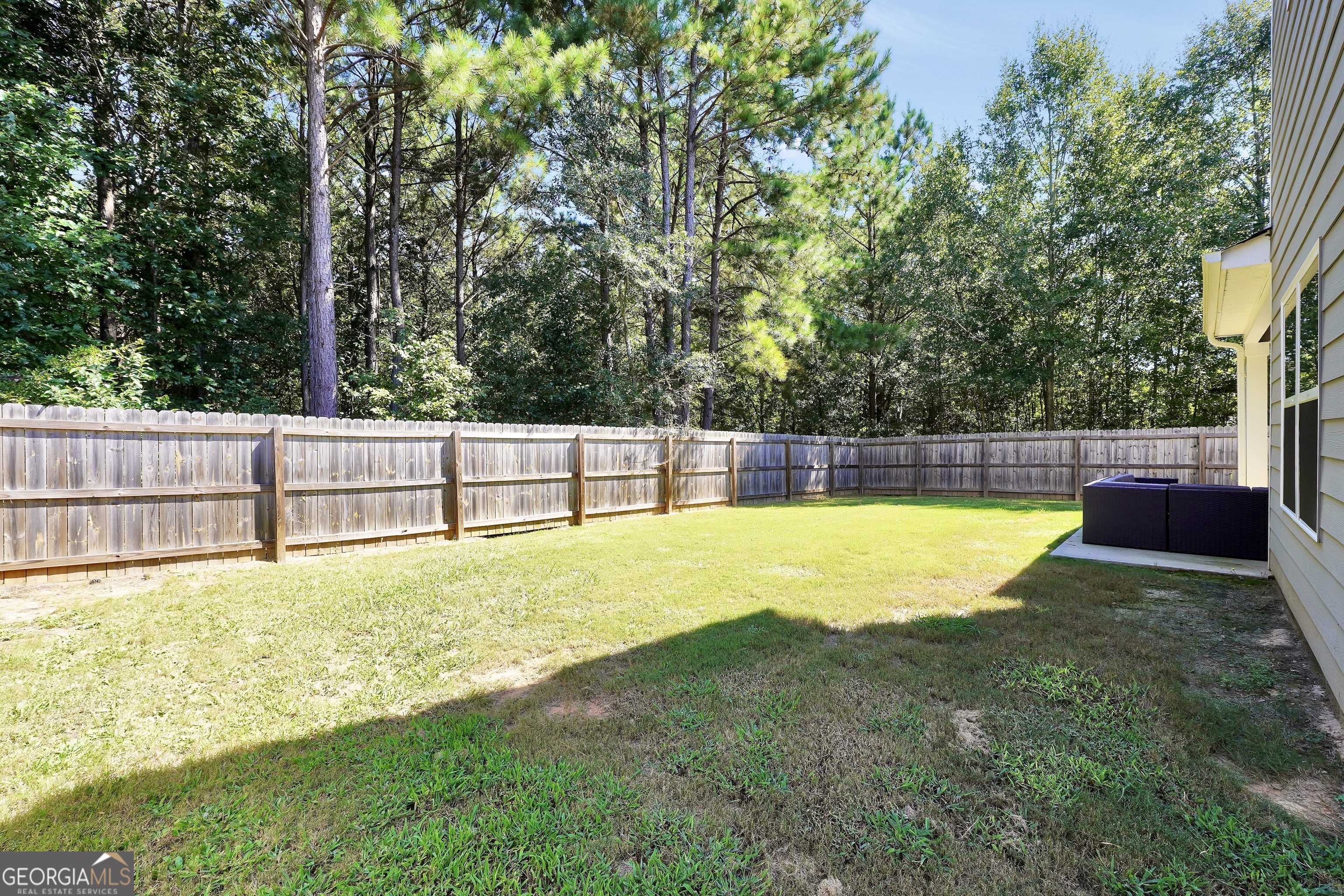 117 Charleston Lane Milner, GA 30257 - Photo 32 of 34 a view of a backyard with swimming pool and trees in the background