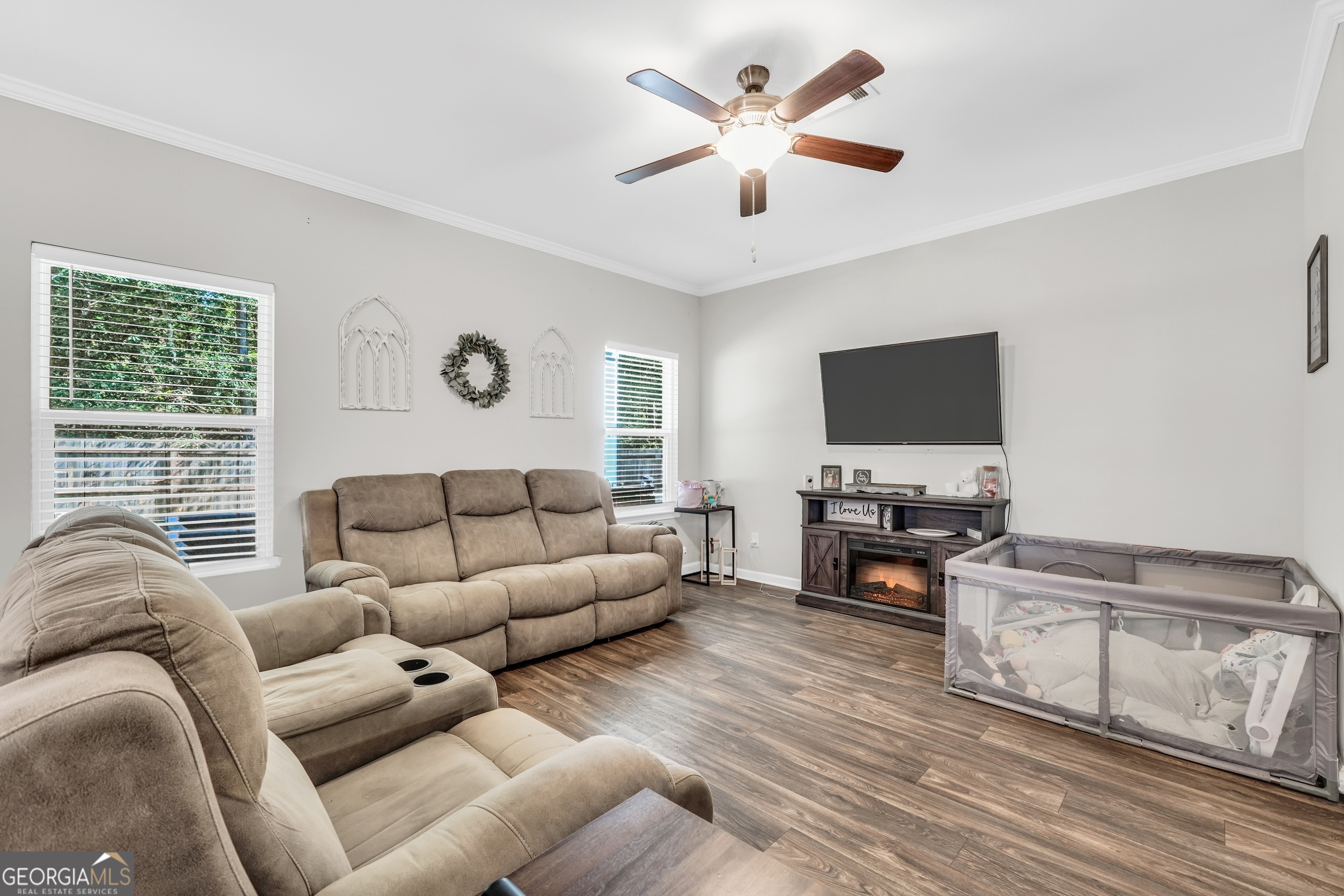 117 Charleston Lane Milner, GA 30257 - Photo 6 of 34 a living room with furniture and a flat screen tv