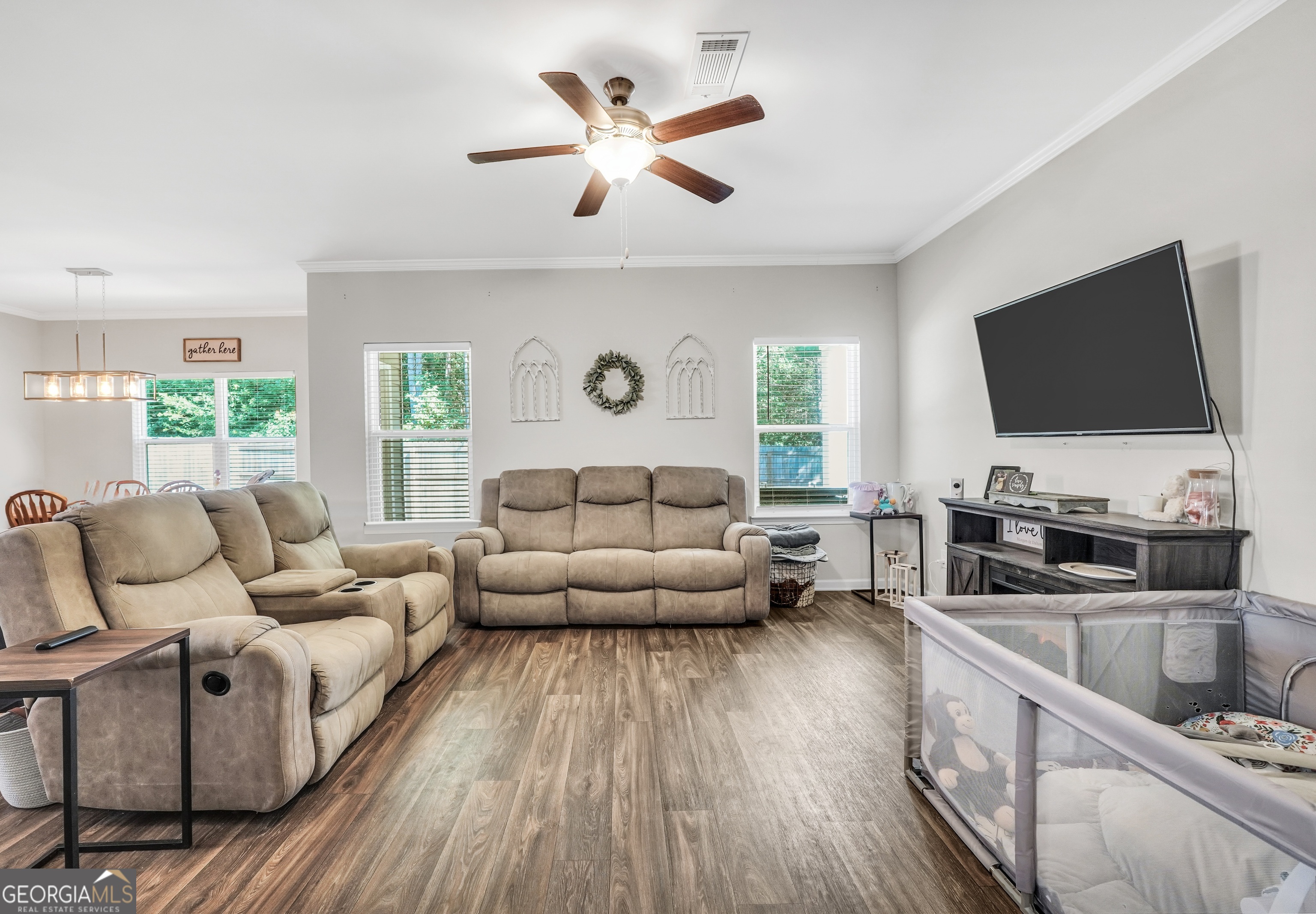 117 Charleston Lane Milner, GA 30257 - Photo 7 of 34 a living room with furniture and a flat screen tv