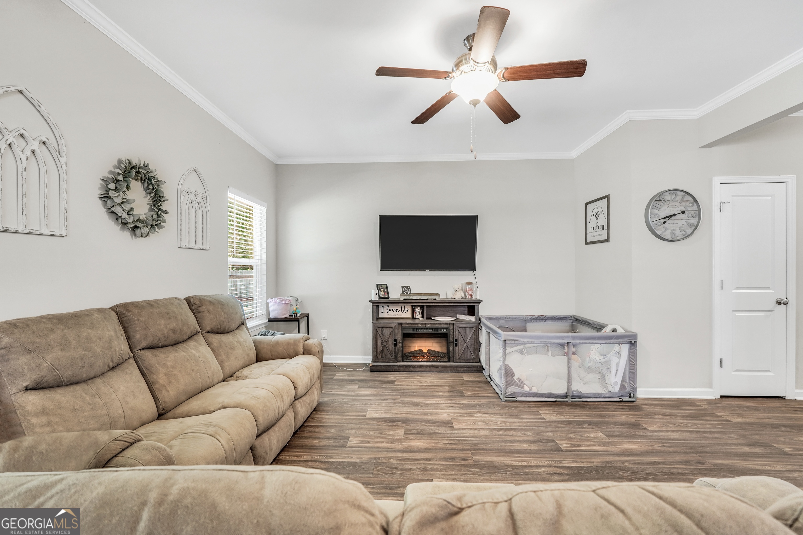 117 Charleston Lane Milner, GA 30257 - Photo 8 of 34 a living room with furniture and a flat screen tv