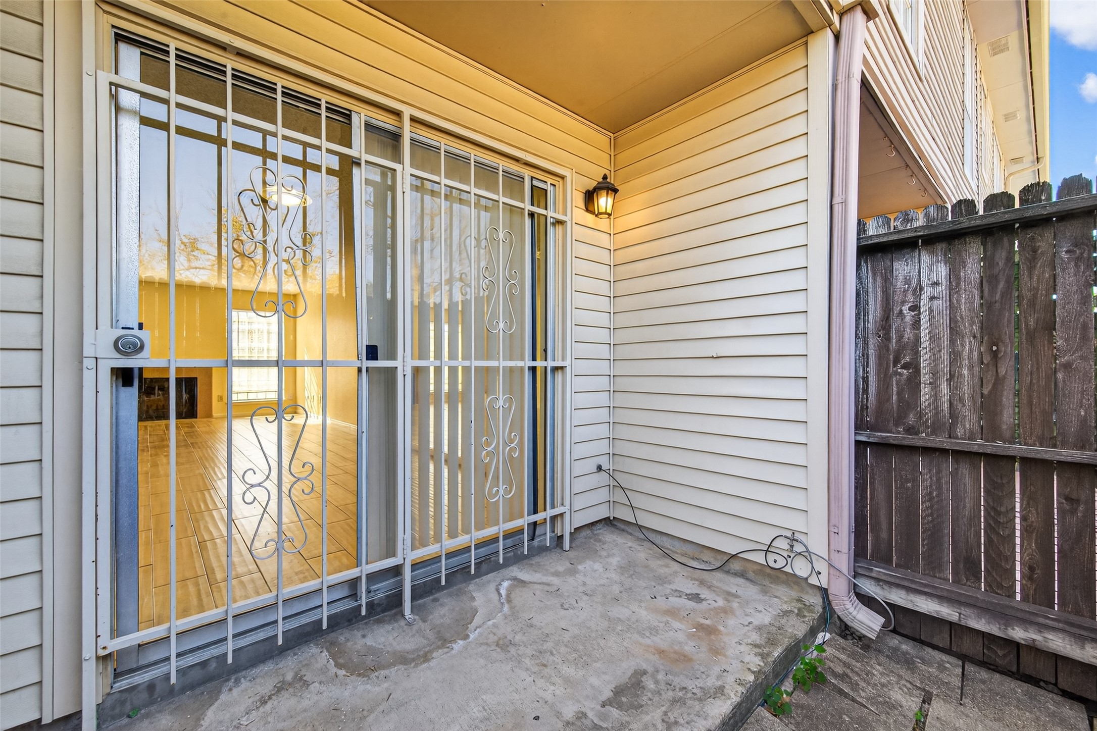 3100 Jeanetta Street, Unit 1004 Houston, TX 77063 - Photo 37 of 42 Through the sliding glass doors lies a fenced patio, a secluded space just the right size for an al fresco dinner or a morning coffee.
