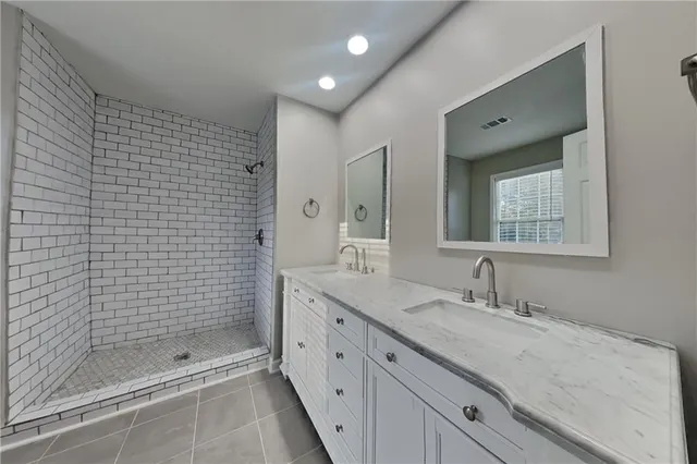 a spacious bathroom with a shower sink and mirror